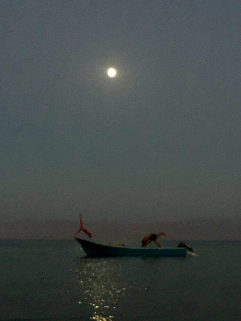 Sinai by dusk and full moon, two people practicing yoga.