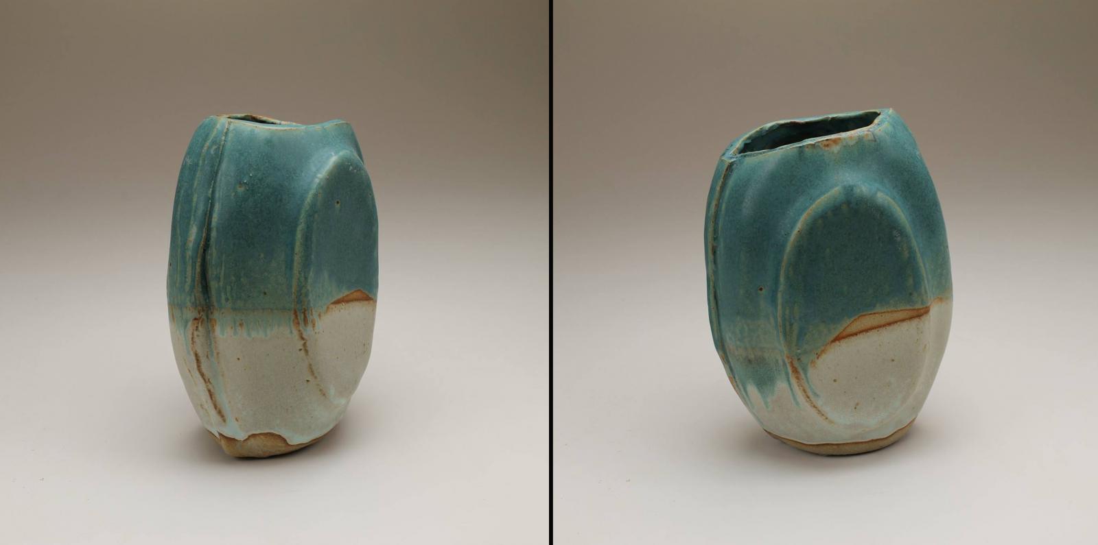 Ceramic vase of two joined slump moulds  with an diagonal opening cut through the clay body at the top of the vase.