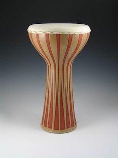 A terra cotta hand drum with geometric pattern in glaze, and a calfskin head finished with a braided pattern.