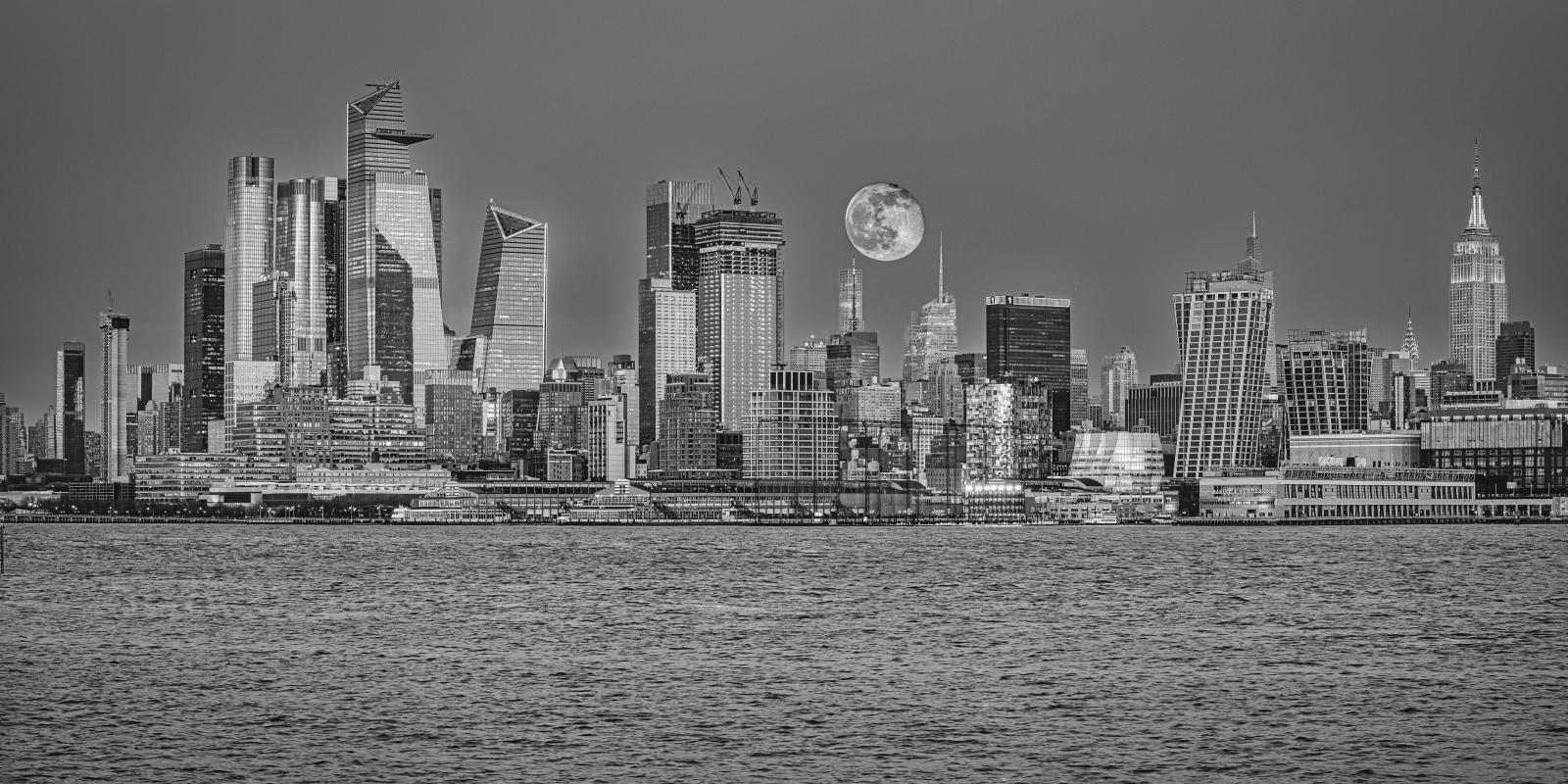 digital photograph of full moonrise over midtown Manhattan taken from New Jersey