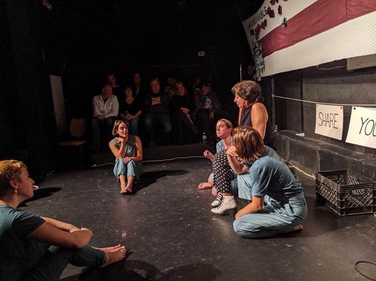 "Hard Feelings: A Show About Grudges" is a humorous exploration of what it means to make, hold, share, and shed a grudge. In the image, the applicants hold the "grudge," which is filled with ingredients offered up by the audience, such as spite, time, and tenacity. "Hard Feelings" is part of a larger body of work called "Say You're Sorry.