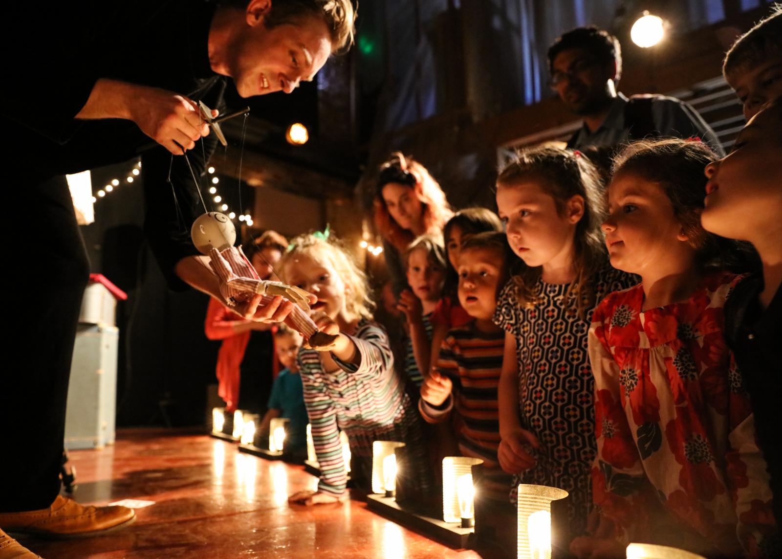 Alex & Olmsted's Jim Henson Foundation Grant awarded "Milo the Magnificent" is a highly engaging puppet show about an aspiring magician. Using stunningly innovative puppetry, Milo presents a variety of magic tricks which don’t always go as planned. "Milo the Magnificent" had its Henson Foundation Grant premiere at Baltimore's Black Cherry Puppet Theater in 2017. Since then, Milo has toured the United States to such prestigious venues as Symphony Space in New York City, the Detroit Institute of Arts in Michigan, The Center for Puppetry Arts in Atlanta, and the Ballard Institute and Museum of Puppetry in Connecticut, among others. Milo has also toured international festivals including the Festival of Wonder in Denmark, the Puppet Festival Chuncheon in South Korea, and the Festival de Casteliers in Montréal, Québec.
Alex and Olmsted invite audiences to the front of the stage to answer questions and demonstrate how the puppets were built. Photo by Kintz at the Jim Henson Foundation Grant premiere at Baltimore's Black Cherry Puppet Theater in 2017.