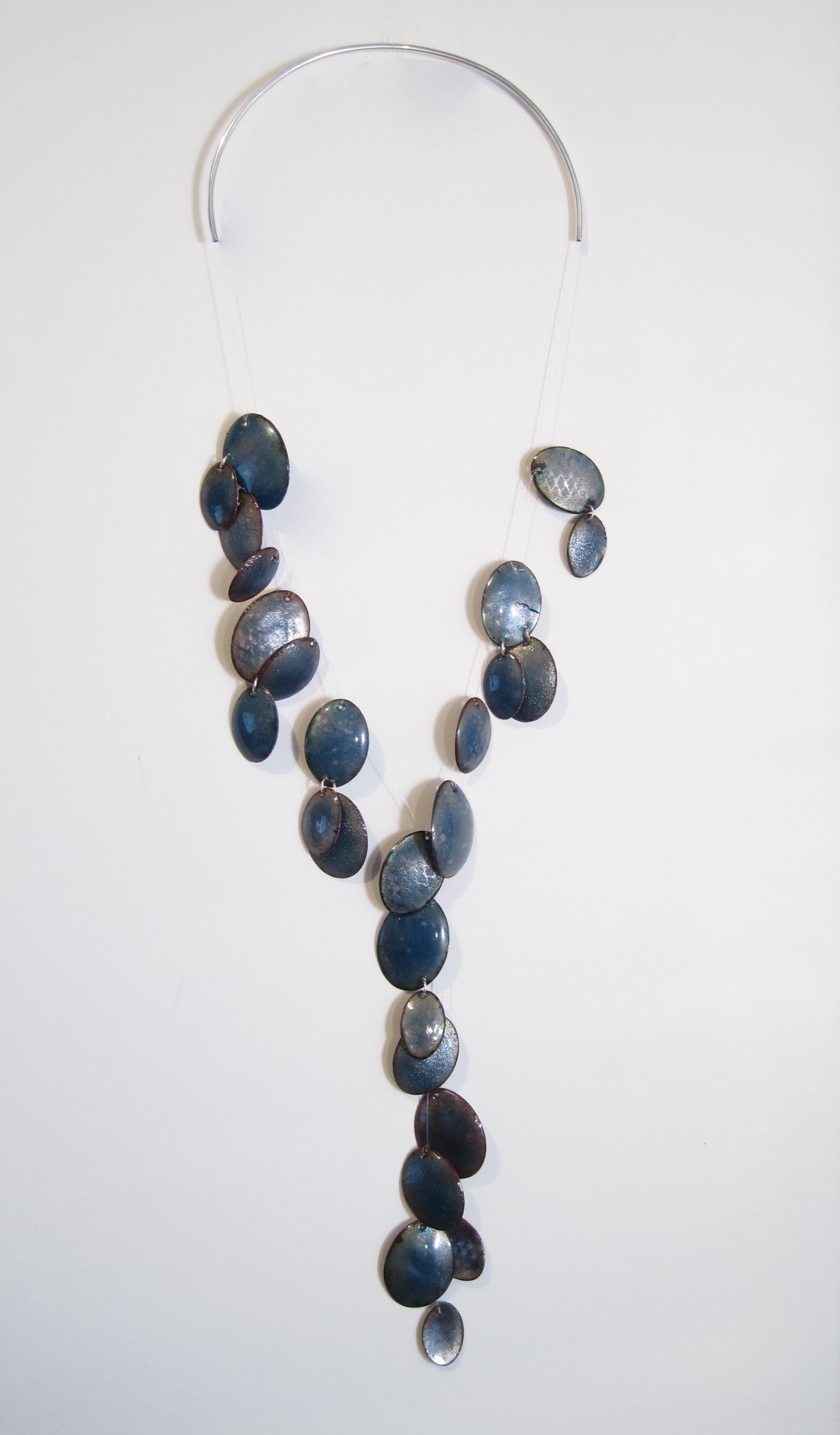 Neckpiece of sterling silver, copper, vitreous enamel and fishing line