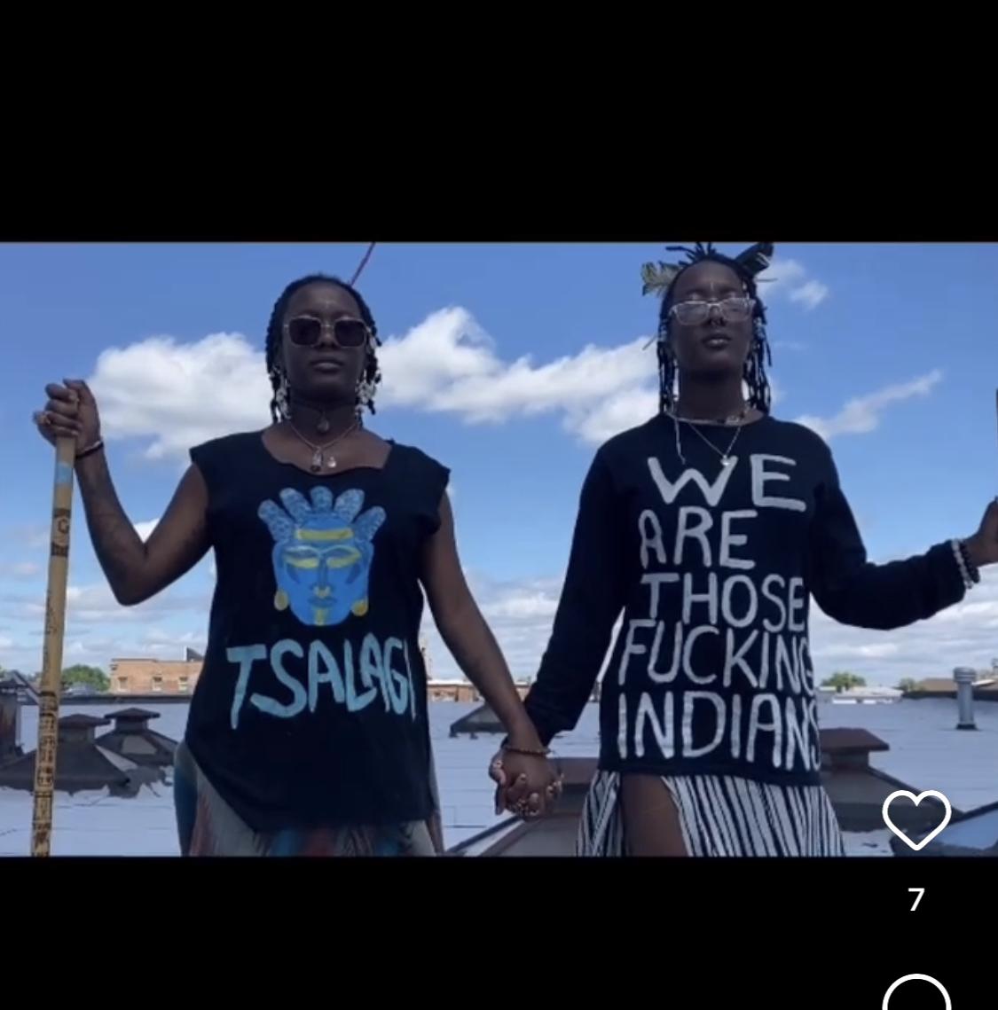 Indigenous Sistar Duo wearing TSALAGI wearable art tee shirt campaign unveiling the indigenous erasure within the Americas against Black Americans and the returning rise of the Matriarchy which is the head of Indigenous Tribal Clans 