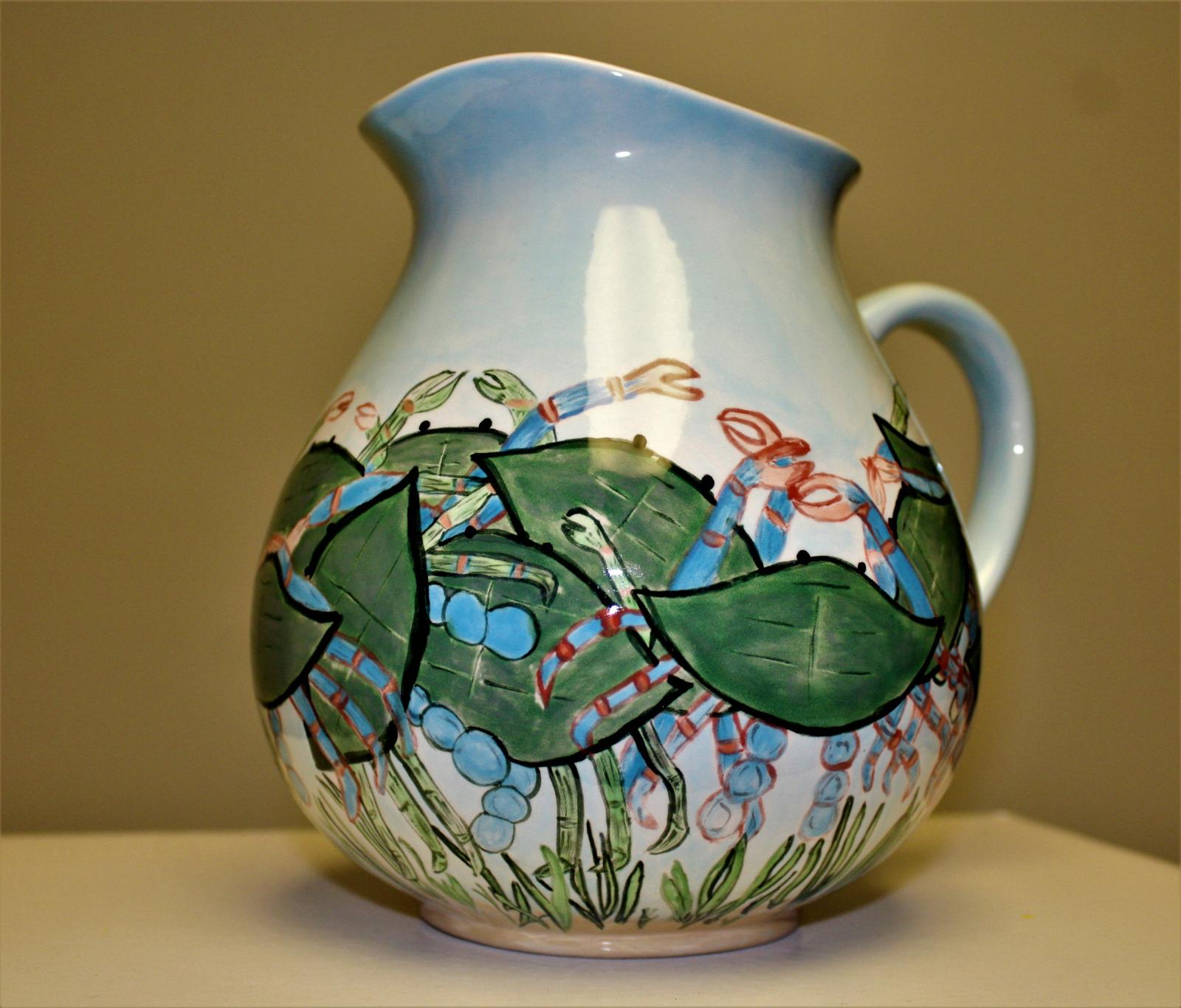 Low fire ceramic water pitcher.  Hand drawn and Hand painted.  I used Stroke and Coat glaze and clear glaze over entire pitcher.  