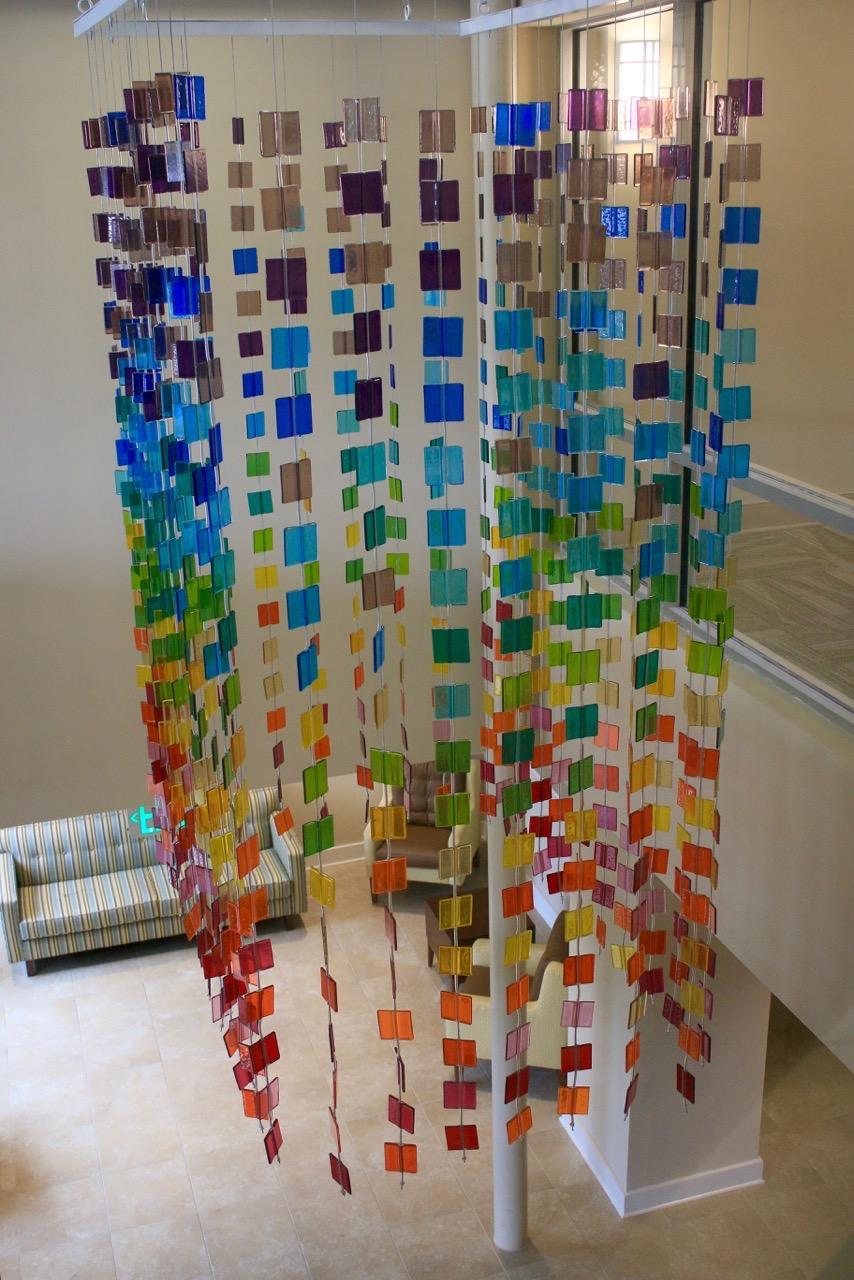 Fused glass tiles in a hanging curtain in Lobby of Linden Park Apartments 