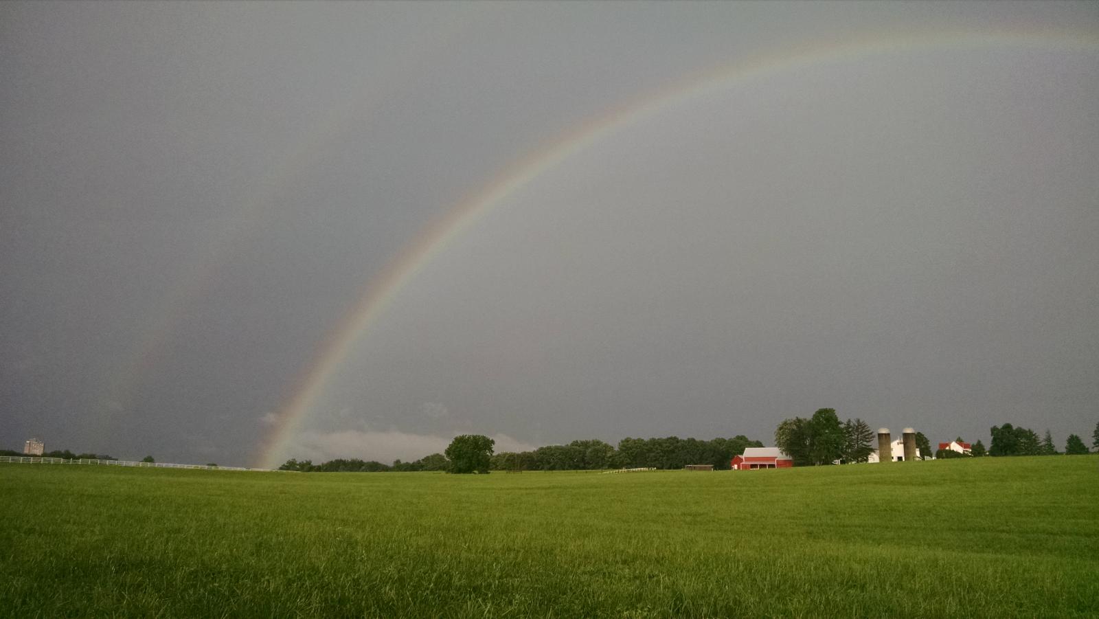 The air crackles with electricity as a double rainbow graces this farm in Darnestown, Maryland.