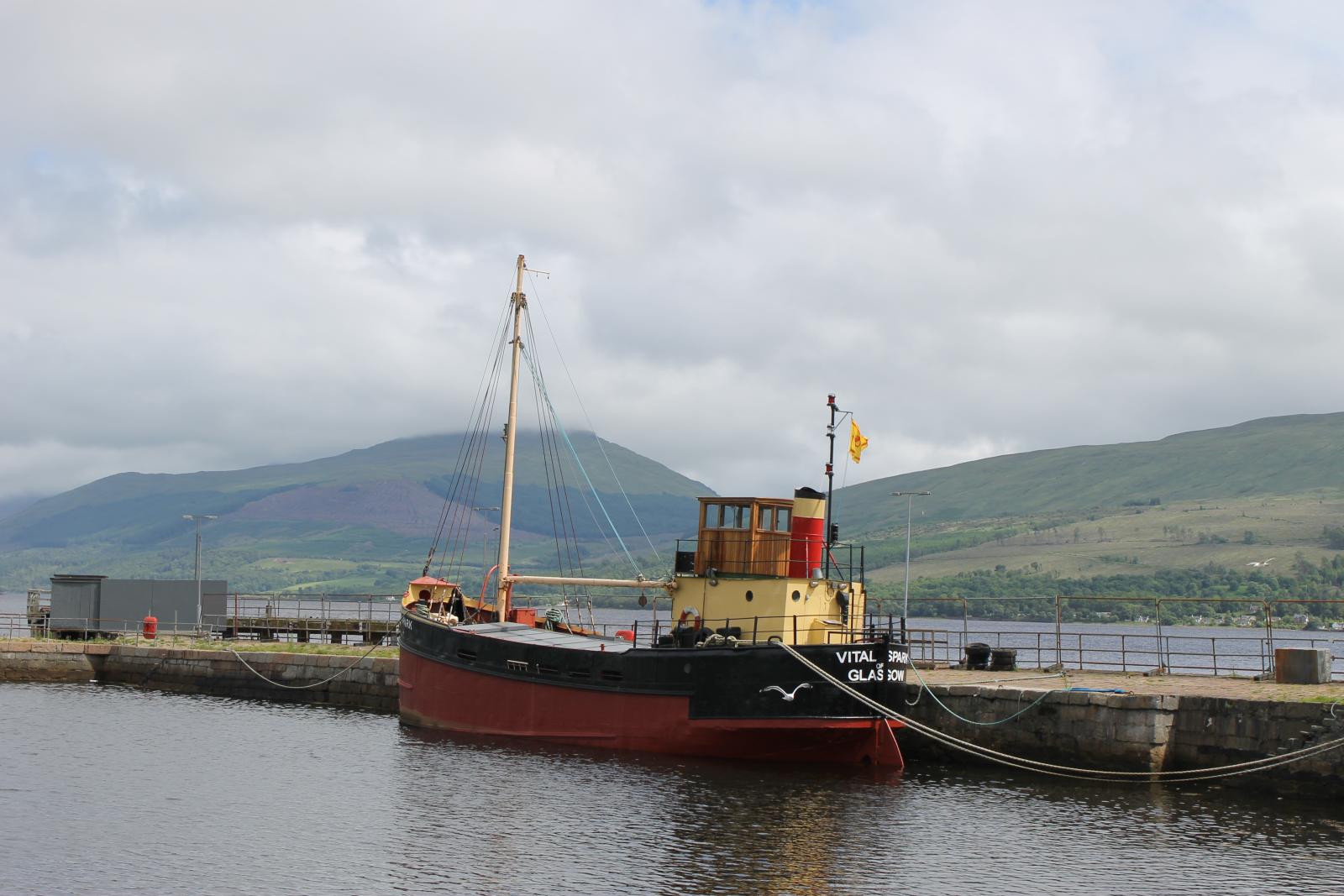 A picture of a boat at dock in Inveraray Scotland named the Vital Spark after the famous puffer created by Scottish writer, Neil Munro.