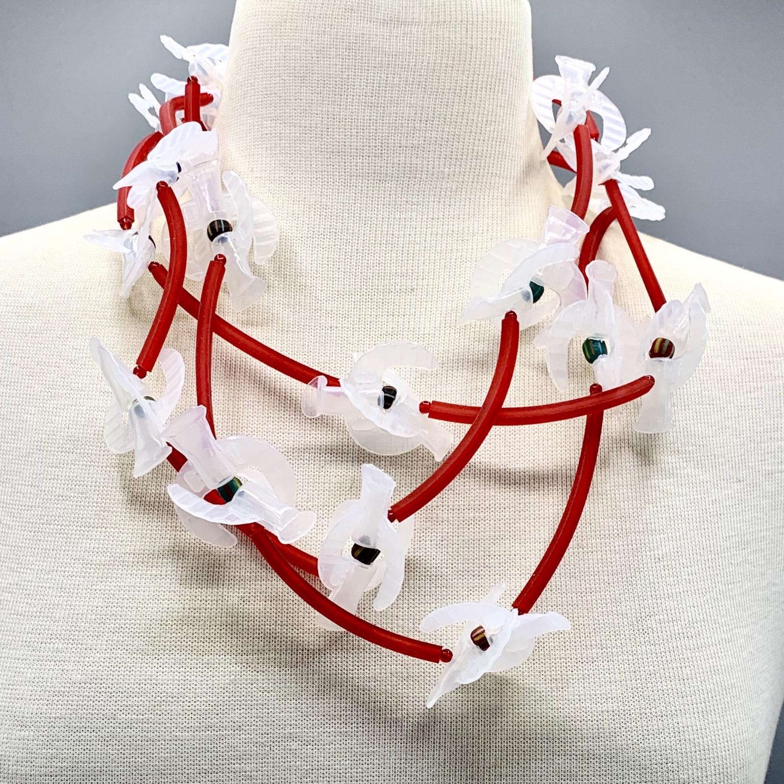 Recycling the tops of children's drinks in a necklace design. A wonderful, playful necklace.