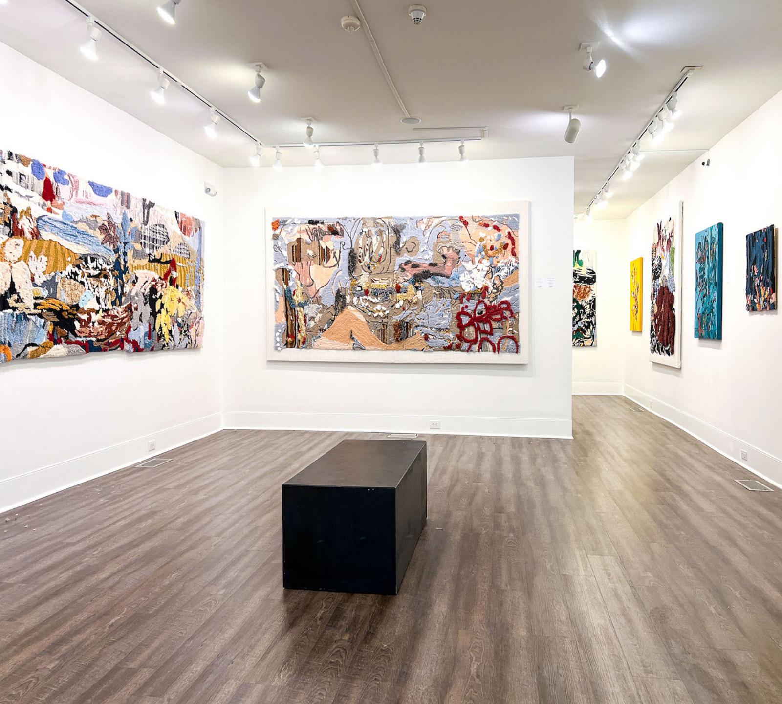 Installation view of exhibition, "Wonderlust" at the Myrtle Beach Art Museum, Myrtle Beach, South Carolina, January 10-April 16, 2023. In view rug tufted paintings and mixed-media paintings.