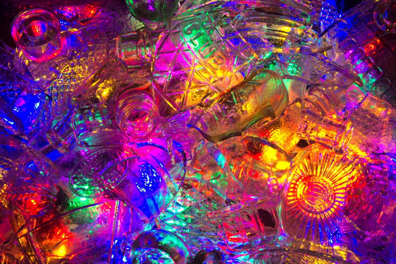 A digital photograph printed on Hahnemühle paper for best quality. This piece is composed of reclaimed broken glass fragments of vintage alcohol bottles and related products ranging from late 1800's to 1940's illuminated by various colored lights.