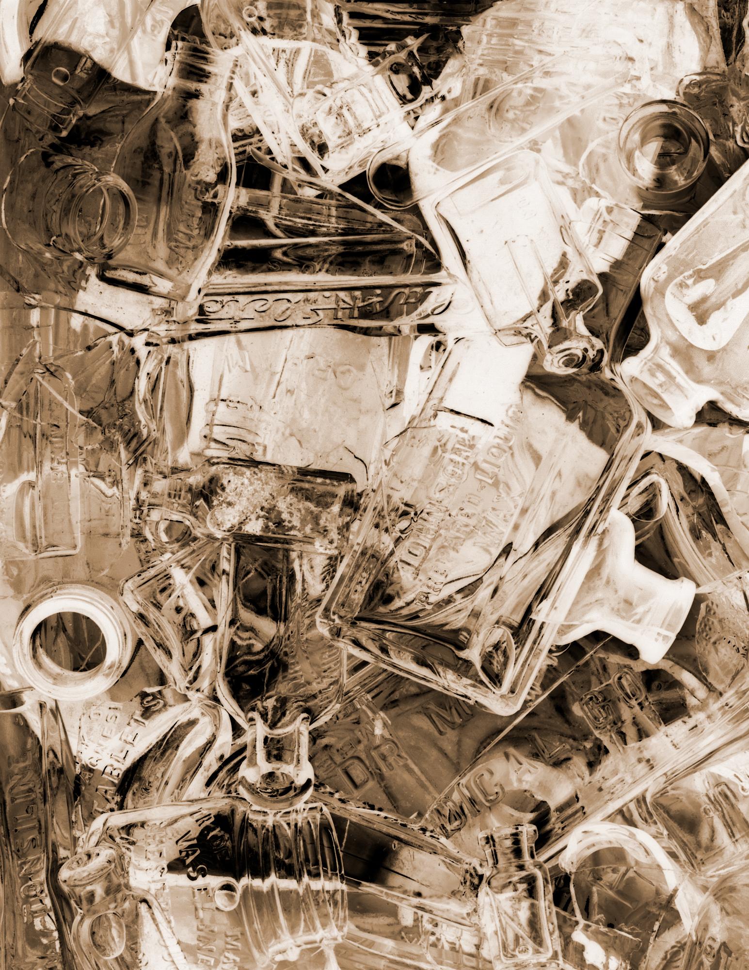 A digital photograph printed on Hahnemühle paper for best quality. This piece is composed of reclaimed broken glass fragments of vintage medical bottles and related products ranging from late 1800's to 1940's. This piece is available in monochromatic grayscale, sepia, and red variants.
