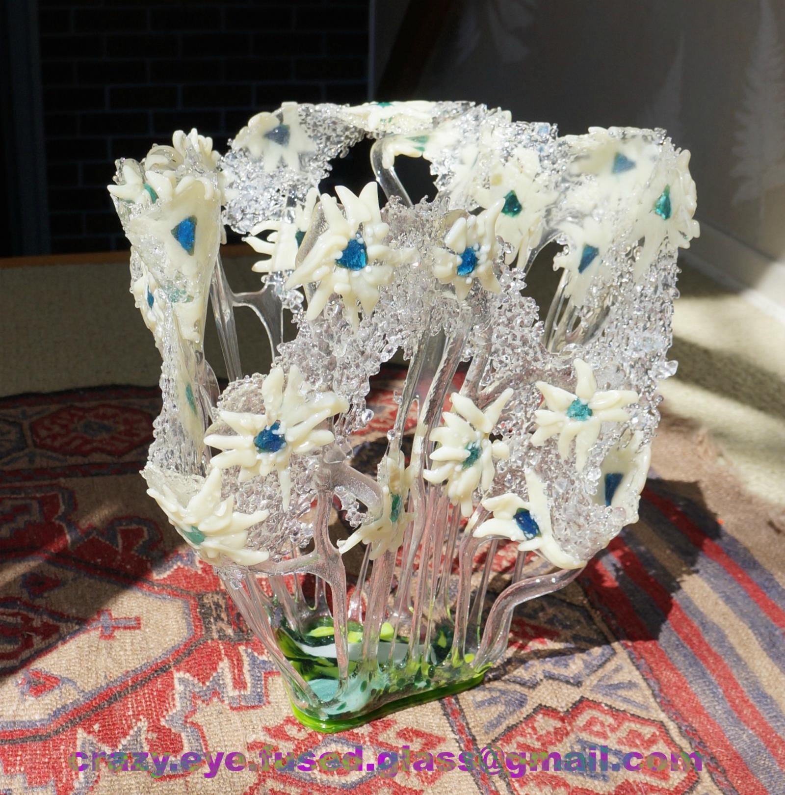 fused glass sculptural piece, creamy petals with blue centers