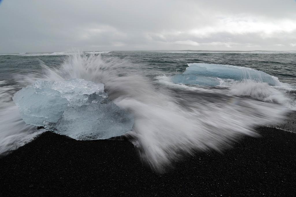 Taken in late winter in Iceland.  A long exposure captures the waves in stop motion.