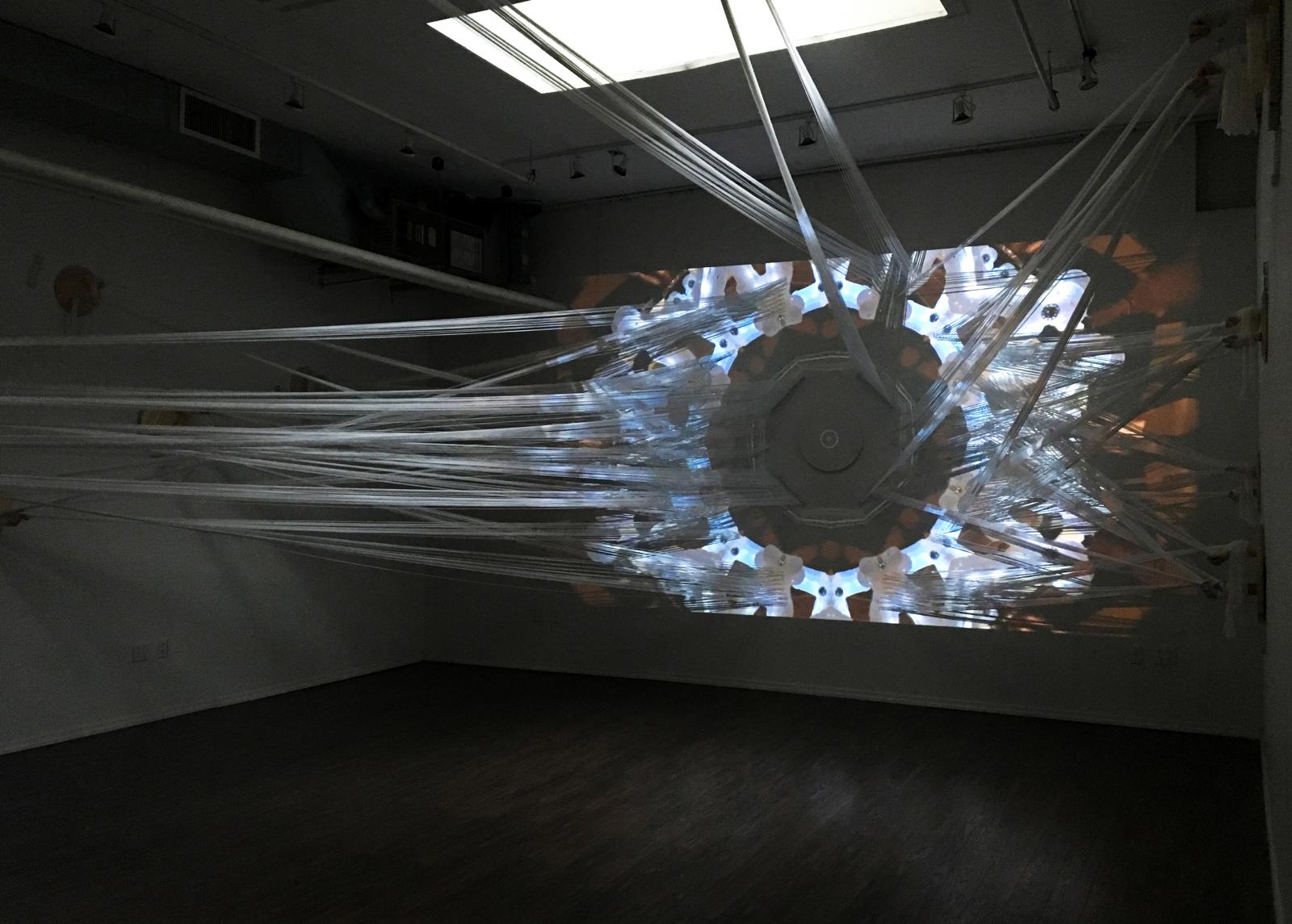 Revealuxion is a video installation using the shapes and mechanisms inspired by cocoons and marionettes. She views herself as a young butterfly, through the reflection of chrysalis as a representation of her alter ego, she expresses suffering and patience that is embedded in her artwork.