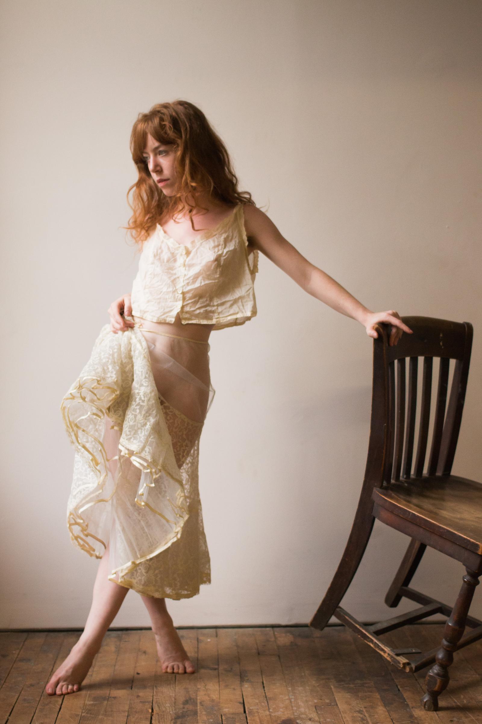 A portrait of a model with a chair.