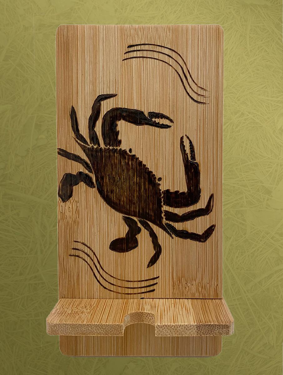 Maryland Crab Phone Stand is a great gift for home or office. The Maryland Crab is depicted with great detail on a bamboo stand. The image is burned by hand with care. No stamps or printing machines are used. Made in the USA.
