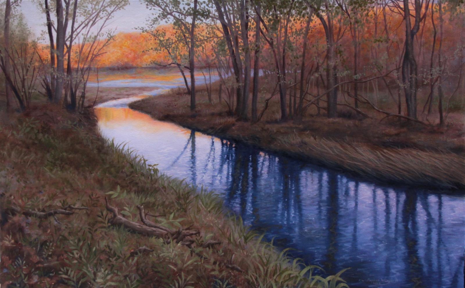 A quiet stream flows into a small lake late one Autumn afternoon.