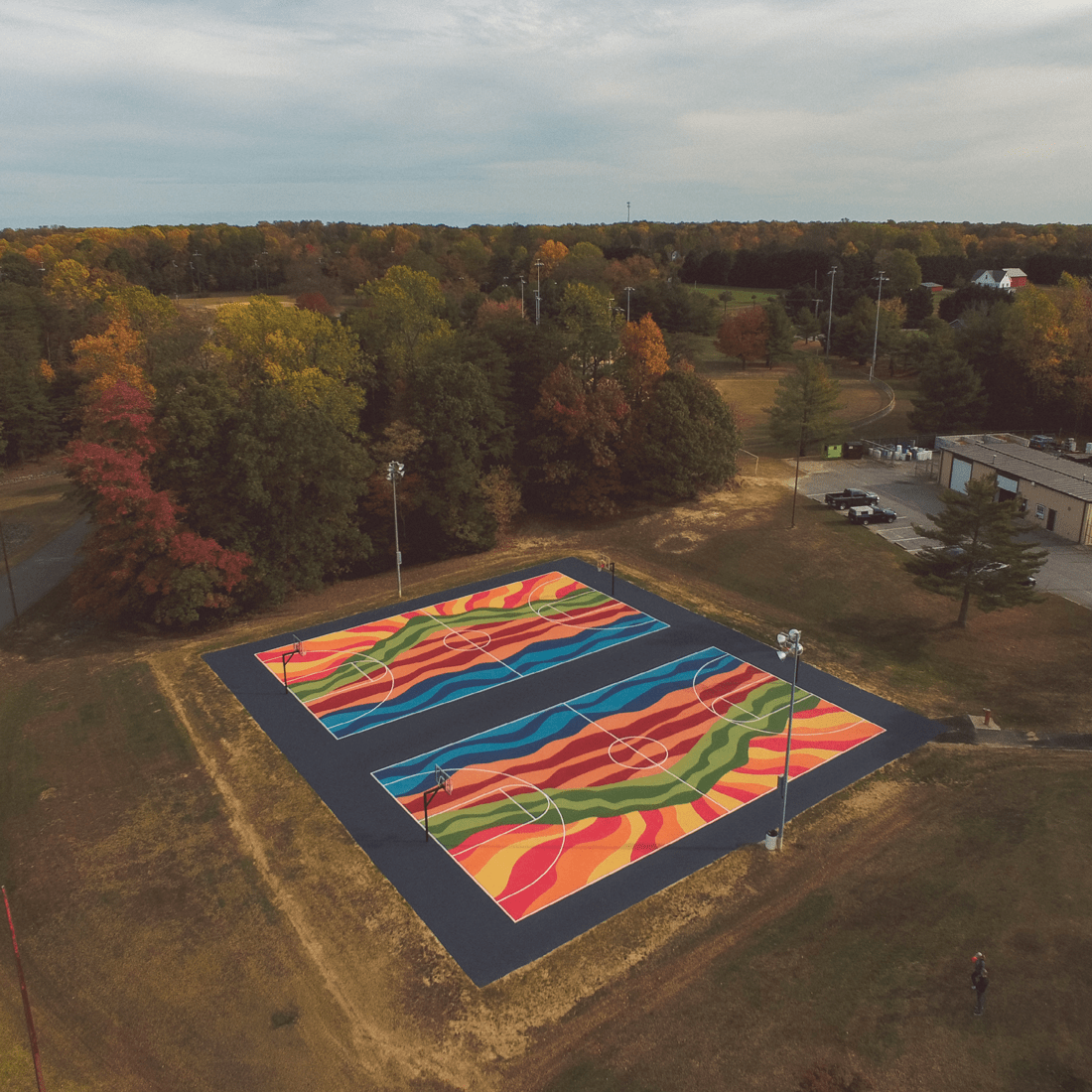 Southern Maryland Quilt Murals is a public art road trip that invites locals and visitors on an exciting journey to explore vibrant, painted quilt murals scattered across the Southern Maryland region. Each mural is uniquely numbered and easily accessible, making it a fun and immersive adventure for all.
This mural was designed by Donald Ely for Three Ring Studio and installed by Midatlantic Asphault.