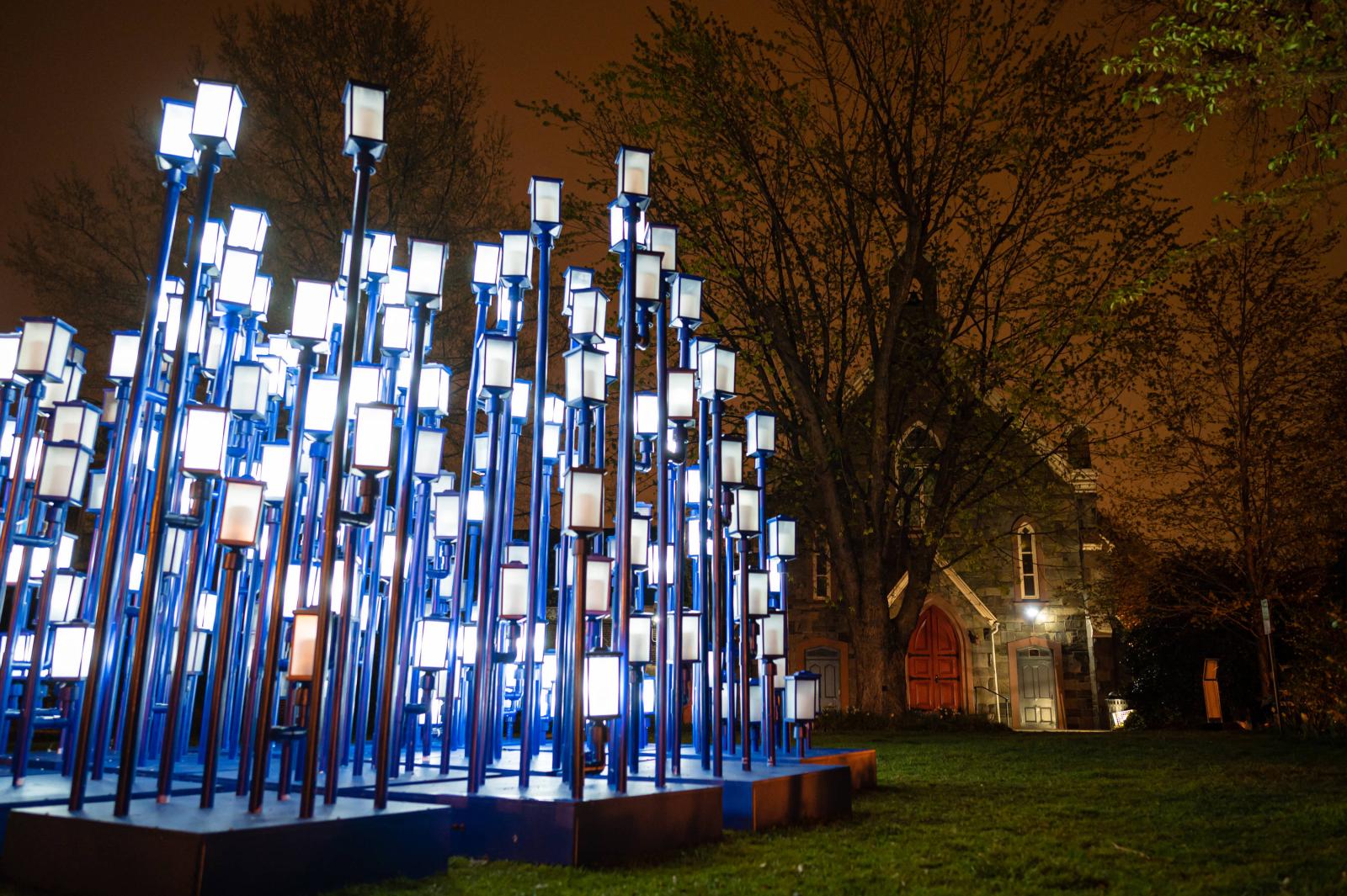 Madness Method was 216 computer-controlled lanterns of varying heights that appeared chaotically arranged, flickering and changing in seemingly random patterns. As visitors explored the piece, patterns slowly become apparent in the placement and brightness of the lights. From a special, marked viewpoint, the lanterns snapped into alignment as a grid, acting as “pixels” in a larger display. The pixels showed a stream of simple images, animations, and text marquees that addressed themes of clarity, unification, human universality and connectedness. It was part of Georgetown GLOW 2021.