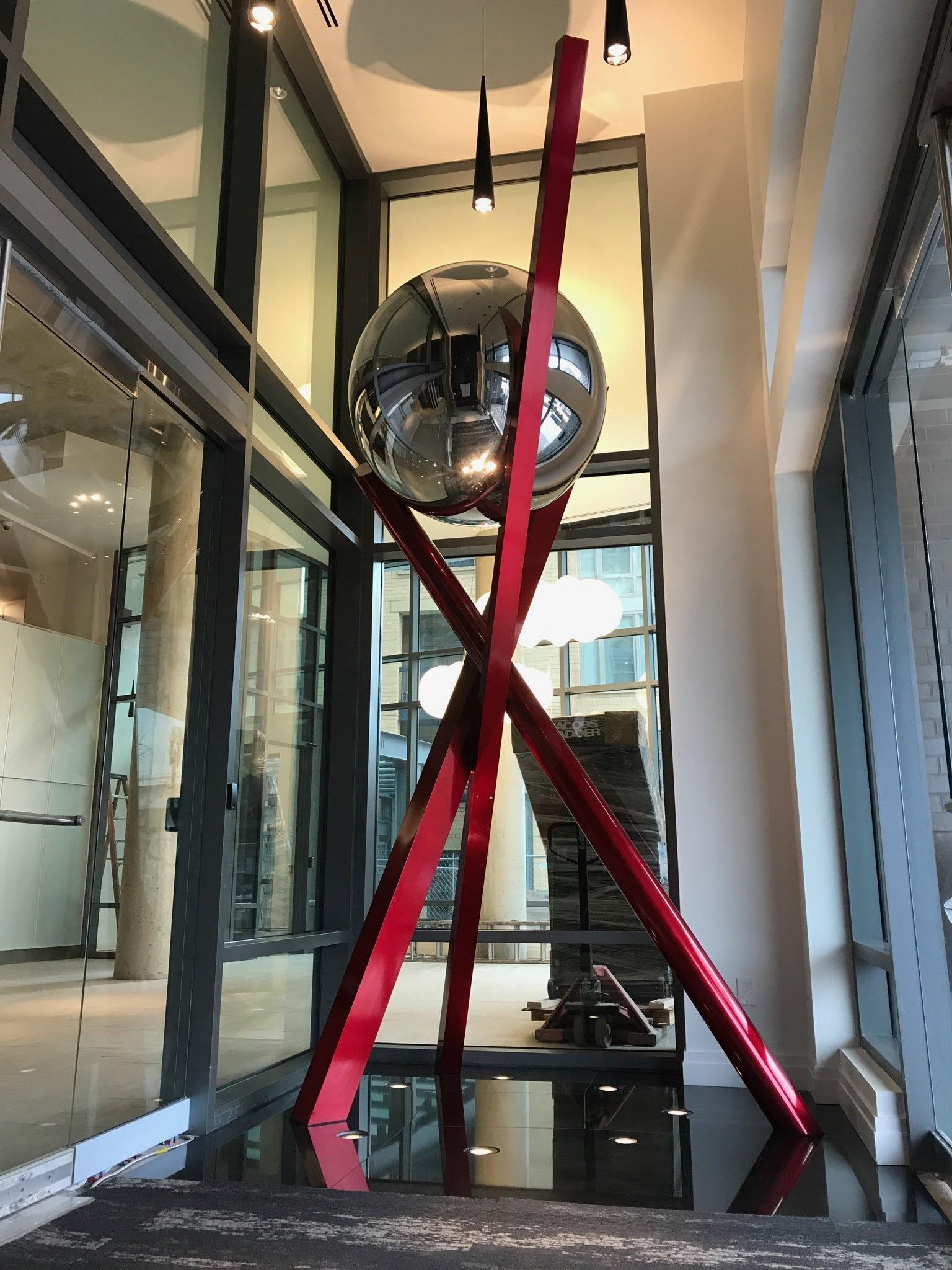 Polished ball “perched” on top of 3 supportive structures. Designed and installed by CMD
