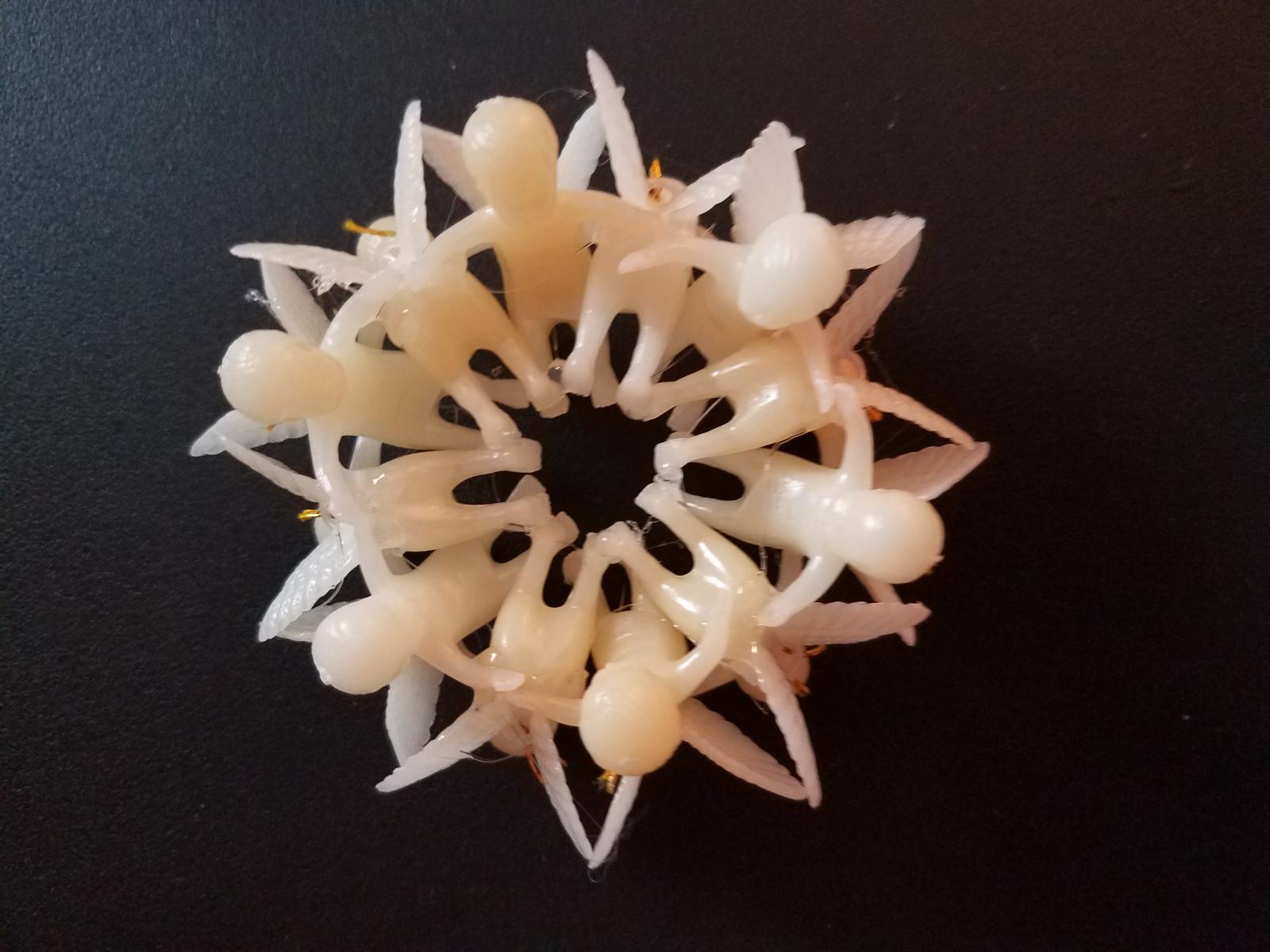 sculpture ring of plastic angel figurines