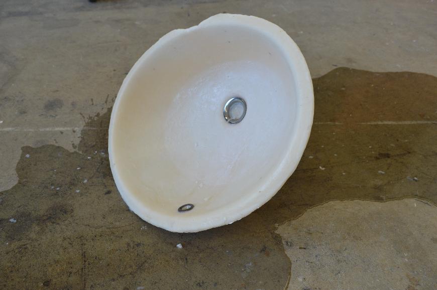 Mother is a sculpture depicting a domestic object; a sink. Originally this piece was displayed set into a 18” x 38” x  ⅜” frosted acrylic sheet. The soap sink was filled with water and left to leak through the bottom where a long stem of hardened soap was attached which haphazardly formed from the canal in the mold.
The goal of the installation is to provoke a subtle sorrow and quietness that feels personal and perhaps nostalgic for viewers, leaving them to reflect on their immediate relationships to home and those considered family.

For me, this piece is a realization - a cathartic process that helped me better understand my relationship to my Mother. All my life my mother has been private, elusive; our relationship is strained and I often feel like strangers. Mother is an expression of my finally feeling close to her after a break in the stagnancy of our relationship: She had passed me in the bathroom after an argument we’d had, and saw me running my hands under hot water - something I do when stressed.
As she quickly passed by, she said “I do that, too.” 