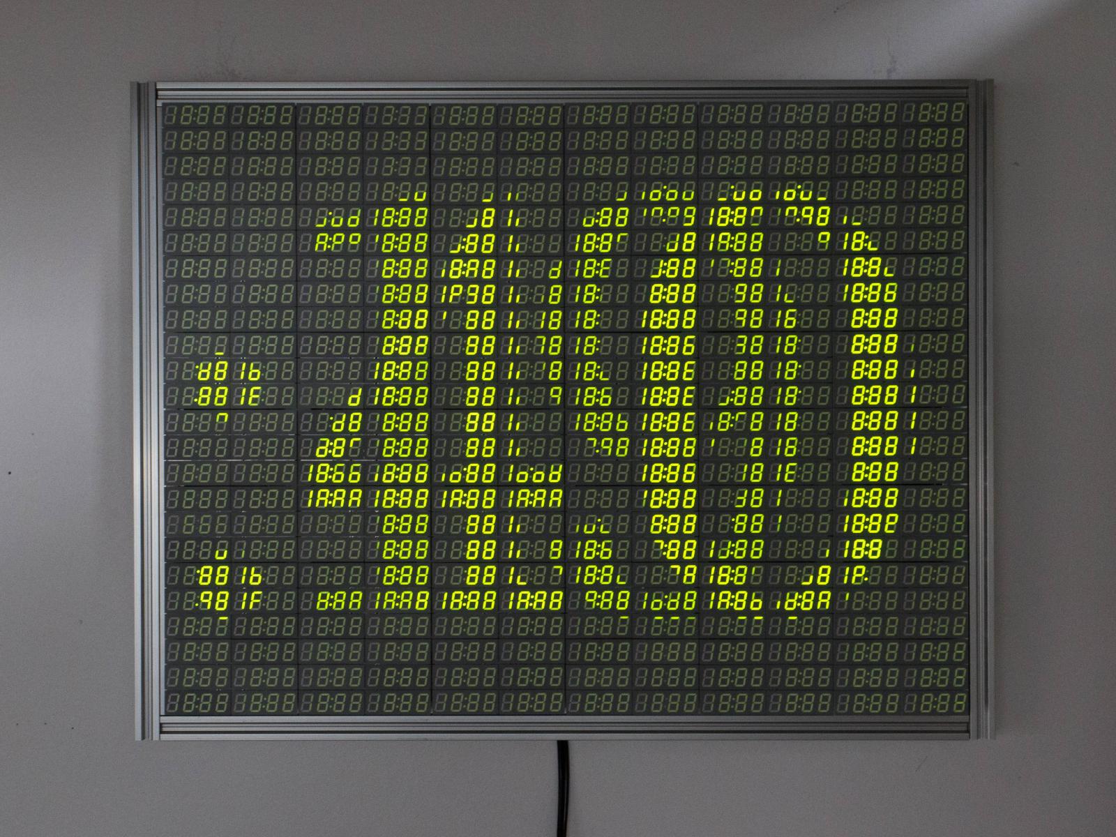 Time-based: Using 1,152 digits in “18:88” clock displays with 7,200 individual pixel elements, this artwork addresses themes of robotics, inevitability, and automation with imagery of fractal trees, geometric increases, countdowns, and scenes from the film Metropolis.