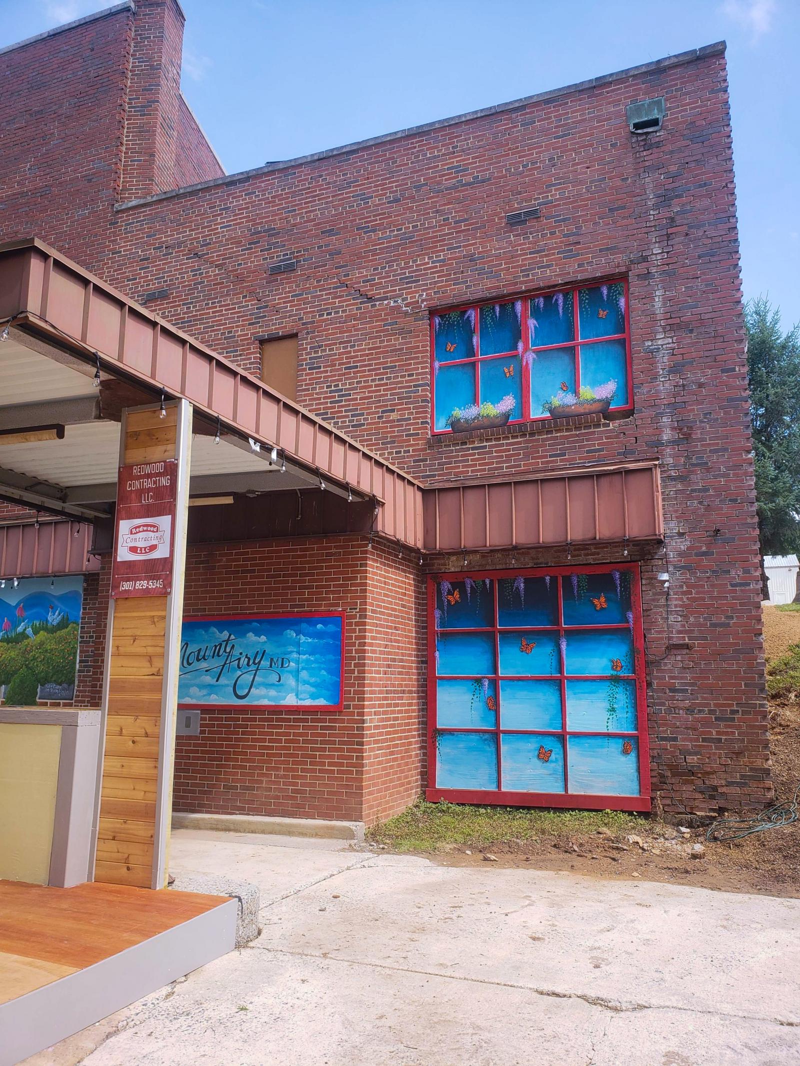 I painted murals for the Mount Airy art council in beautifying an abandoned bank building. I painted the boarded up windows to look like windows with butterflies and flowers. And I painted the garage door look as well as the Mount Airy sign.