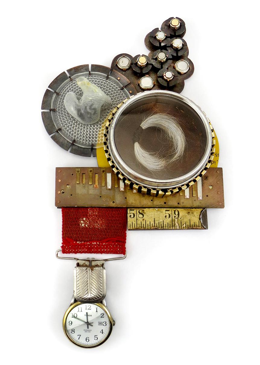 This piece was created for my sister who is a teacher of the deaf. The piece is comprised of a piece of my father's suspenders, a mold of his ear used to create one of his many hearing aids, hearing aid batteries, a piece of his jack knife carrier, his watch band, one of his watches, a piece of his folding ruler, a piece of one of his harmonicas, copper plate and copper rivets.