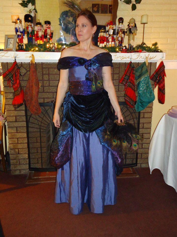 This is a gown that was a commission piece. Restyled from a simple strapless gown to create a Victorian Style Gown for a themed New Year's Eve Party. I used other recycled materials such as fabrics from curtains and other dresses to create this piece as well as vintage jewelry and real peacock feathers as finishing touches.