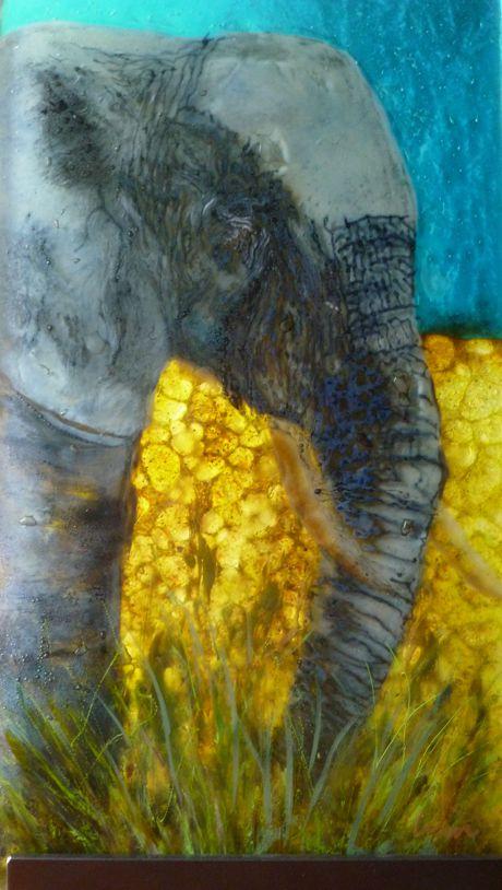 African Elephant was conceived from a photo I took while on an African Safari.  The piece consists of three panels of clear glass.  I drew parts of the image on each panel, used glass frits and glass paint, on each panel, fused the separate sheets in a kiln then placed them together and fused into one solid piece of glass.  The finished piece appears to be 3-dimensional because of the technique.