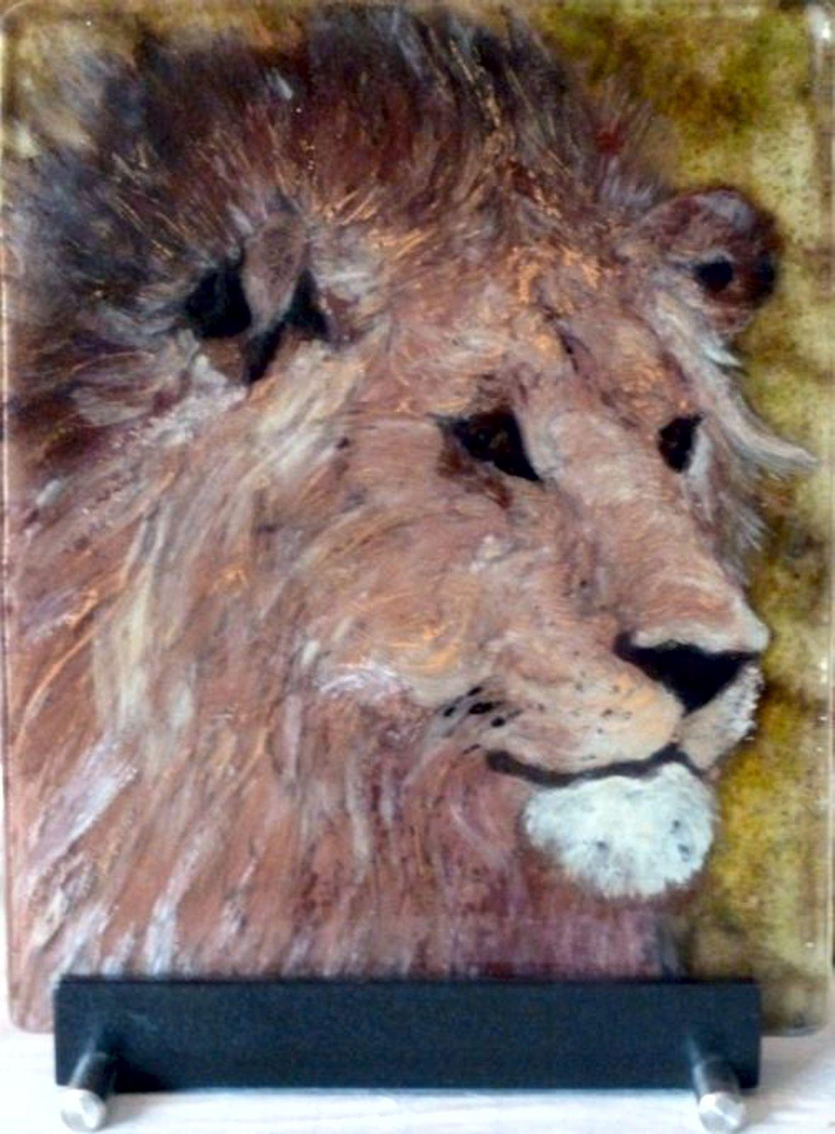 Lion King is created in fused glass using glass frits and glass paint.  Three sheets of glass are used with part of the image on each panel.  When fused together, the work appears to be 3 dimensional.