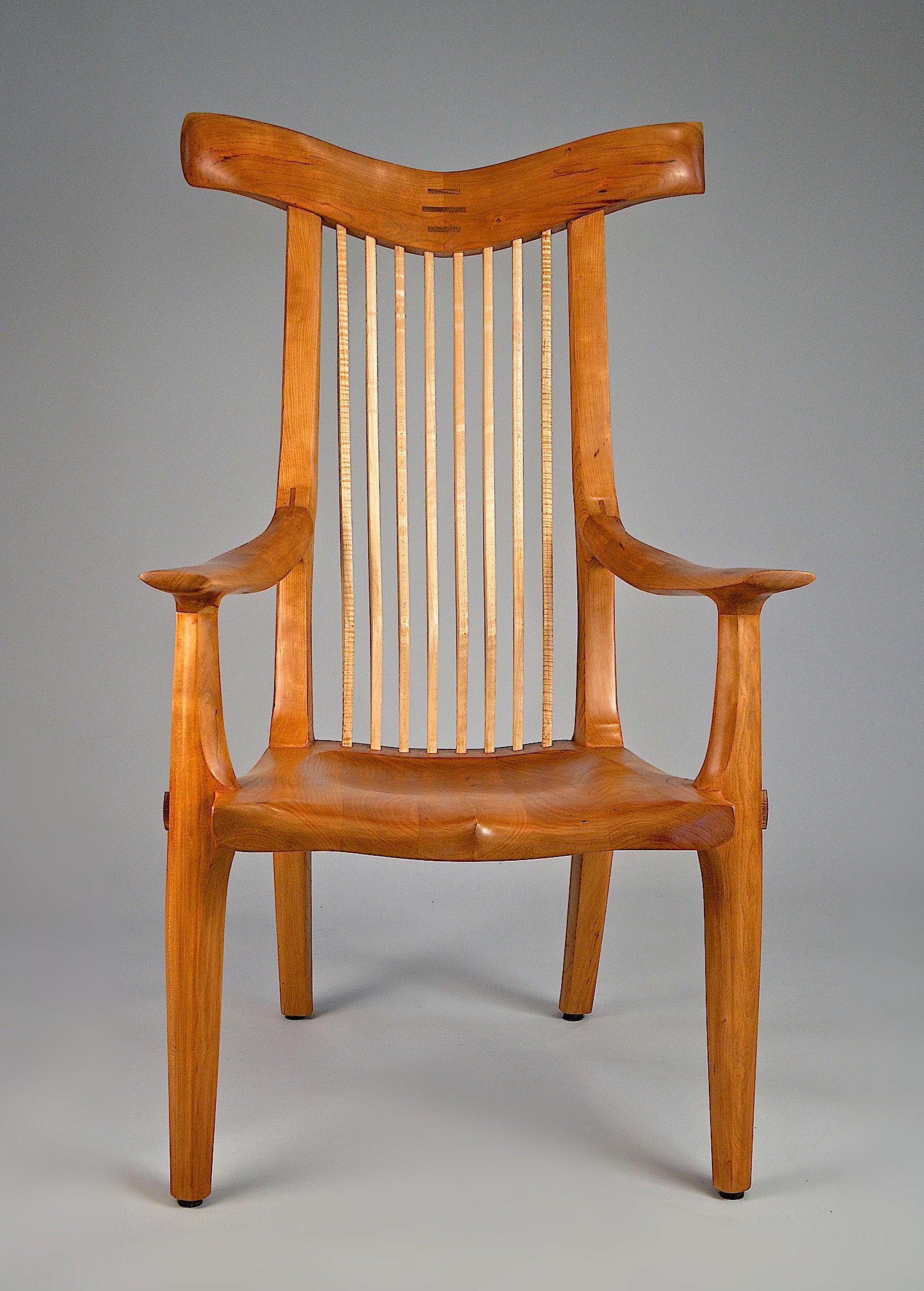 Spindleback library chair in cherry and curly maple, with fluted crest rail and deeply sculpted seat