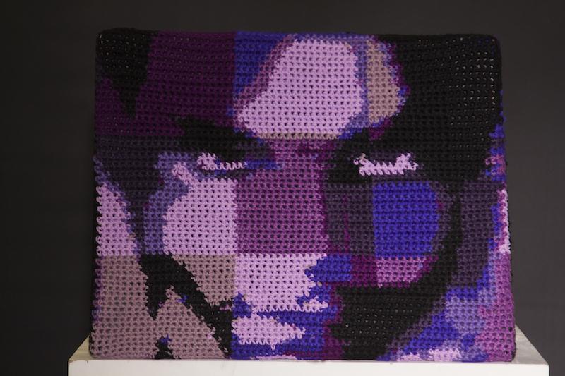 Hand crocheted abstract portrait of the late Prince Rogers Nelson. The portrait is created from acrylic yarn.