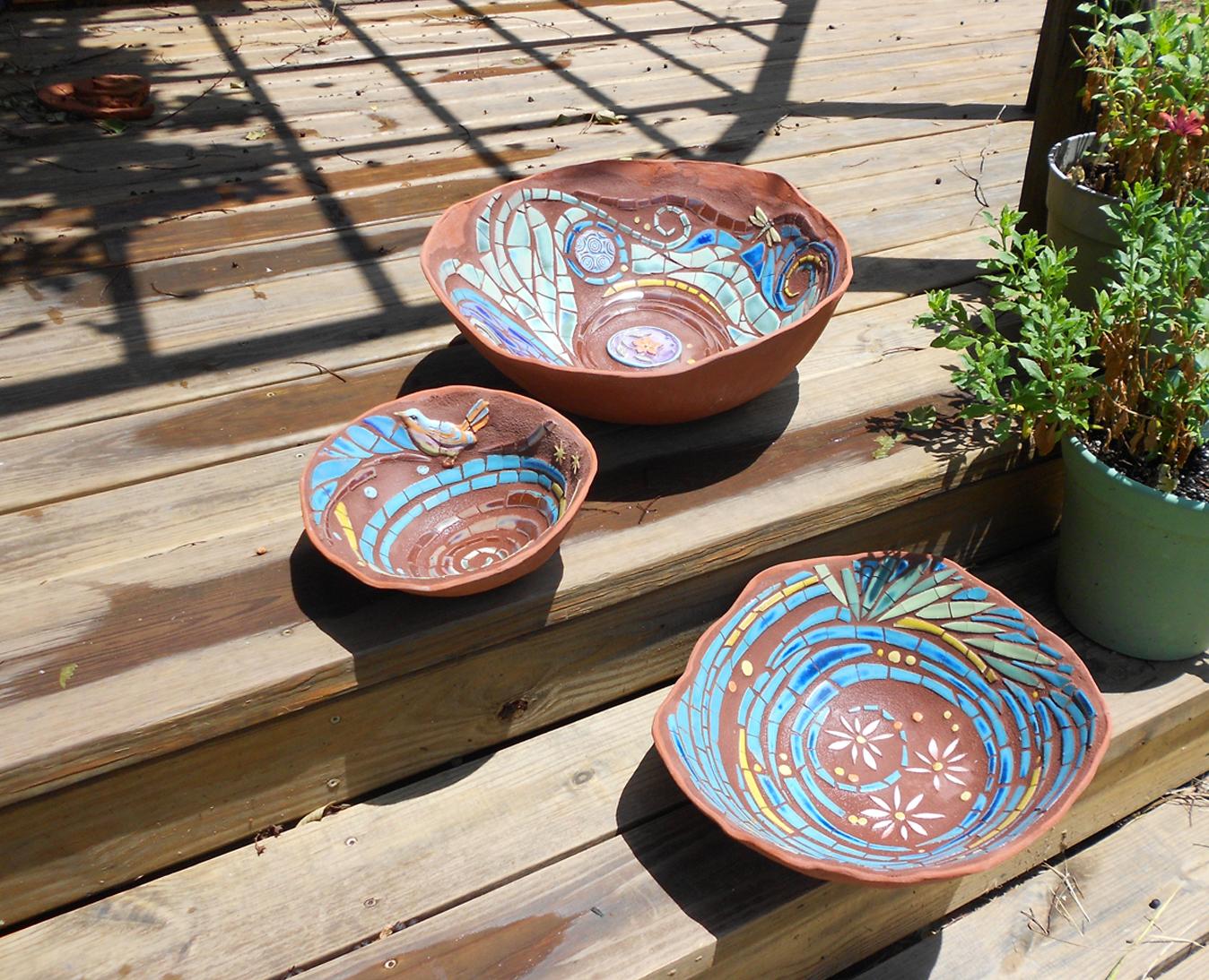 Hand formed terra cotta vessels with mosaic interior surface.