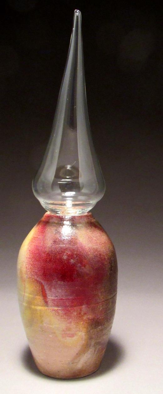 A raku base with a blown glass topper. Made to fit each other.