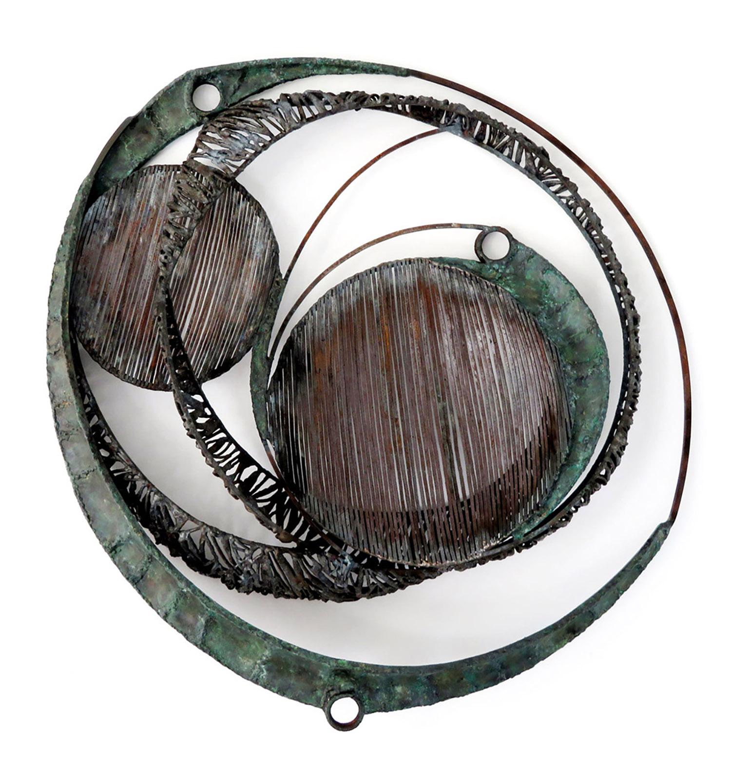 Ritual explores the use of various textures and weights of steel. The spherical shapes convey a sense of movement and of elements orbiting in and around one another. The subtle use of color helps to define the solid shapes and offset the textural elements.