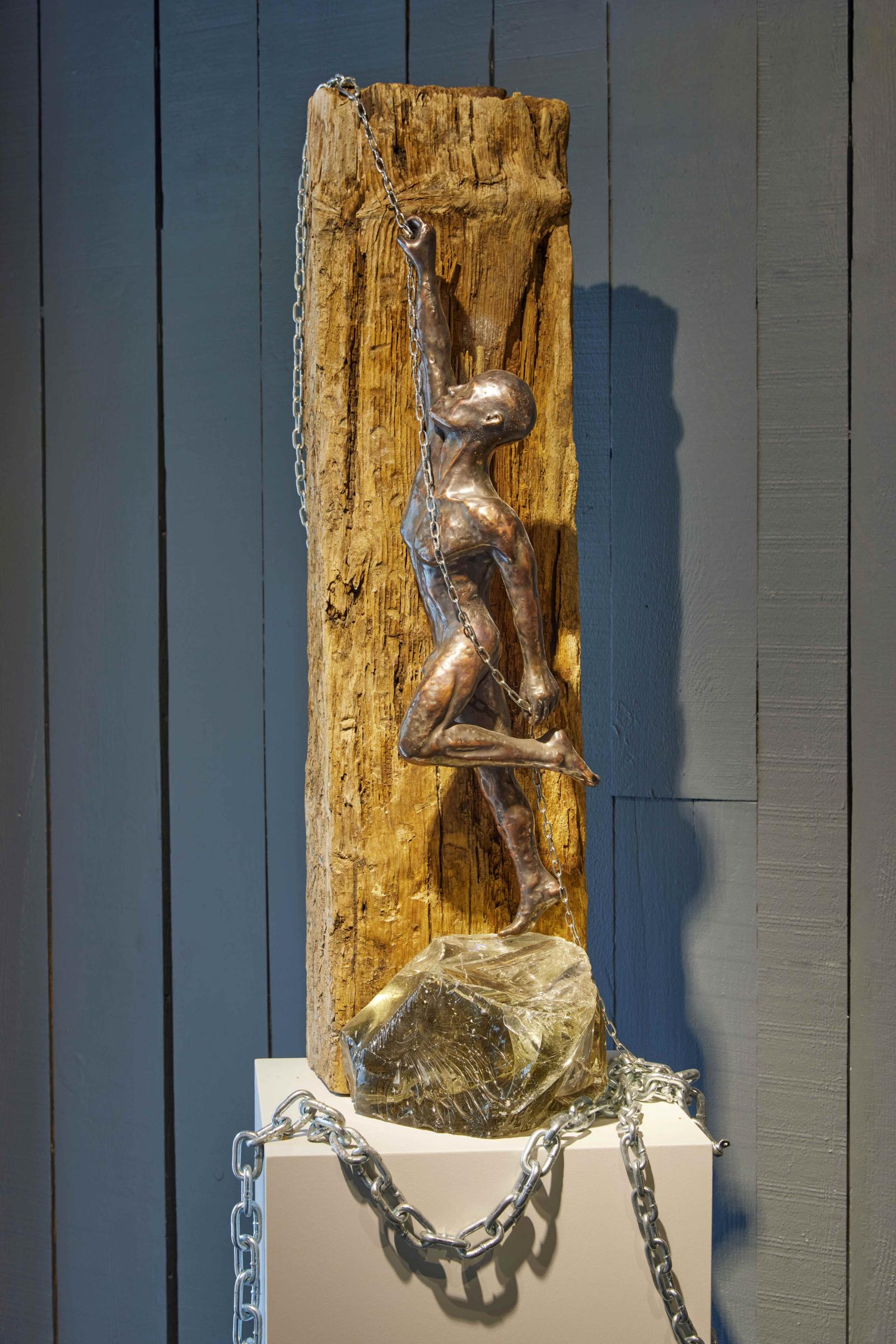 This sculpture depicts a figure striving toward their goals, working and struggling with determination. Yet in the pursuit of what they desire, the figure becomes entangled—bound by attachments, trapped by the very things meant to aid their journey. It reflects the paradox of human effort: in seeking freedom and fulfillment, we often find ourselves held captive by unseen forces. The piece captures the tension between aspiration and entrapment, inviting viewers to reflect on the delicate balance between striving for our dreams and the unseen bonds that can shape or limit us.