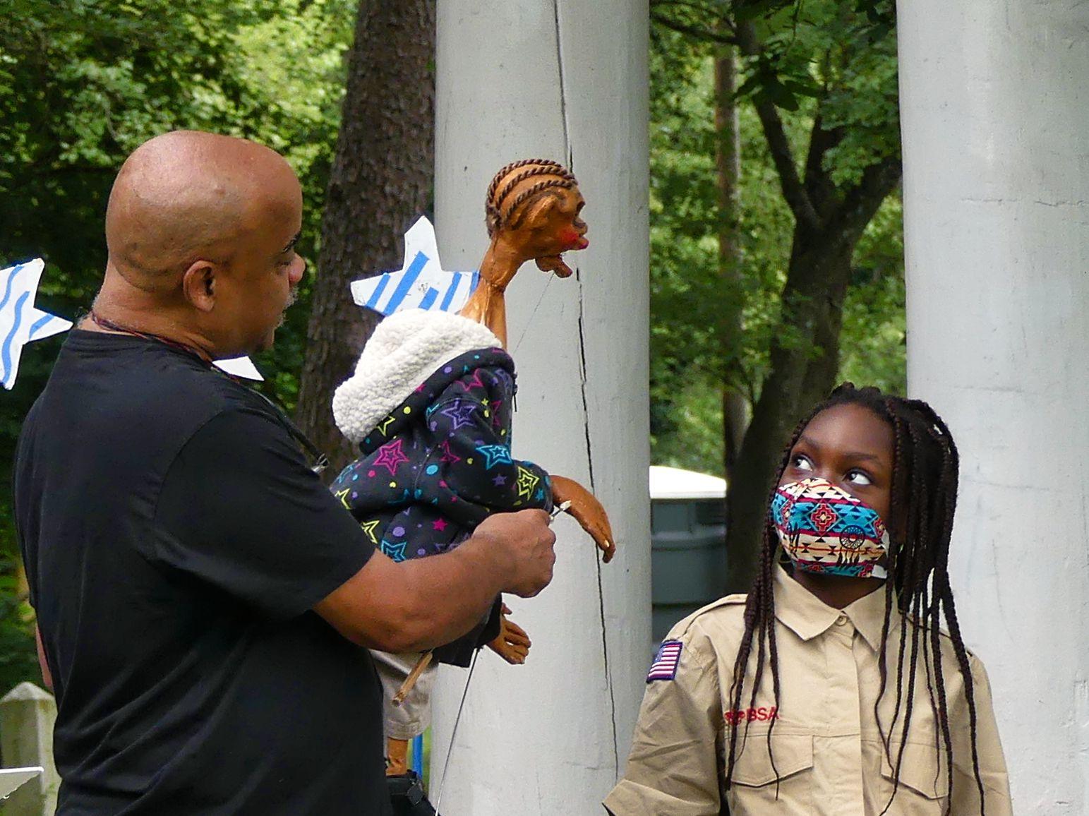 A moment from the puppet show of Schroeder Cherry & His Puppets, as he speaks to a young viewer at Overlea ArtsFest 2021. Photo by Media Service Studio.