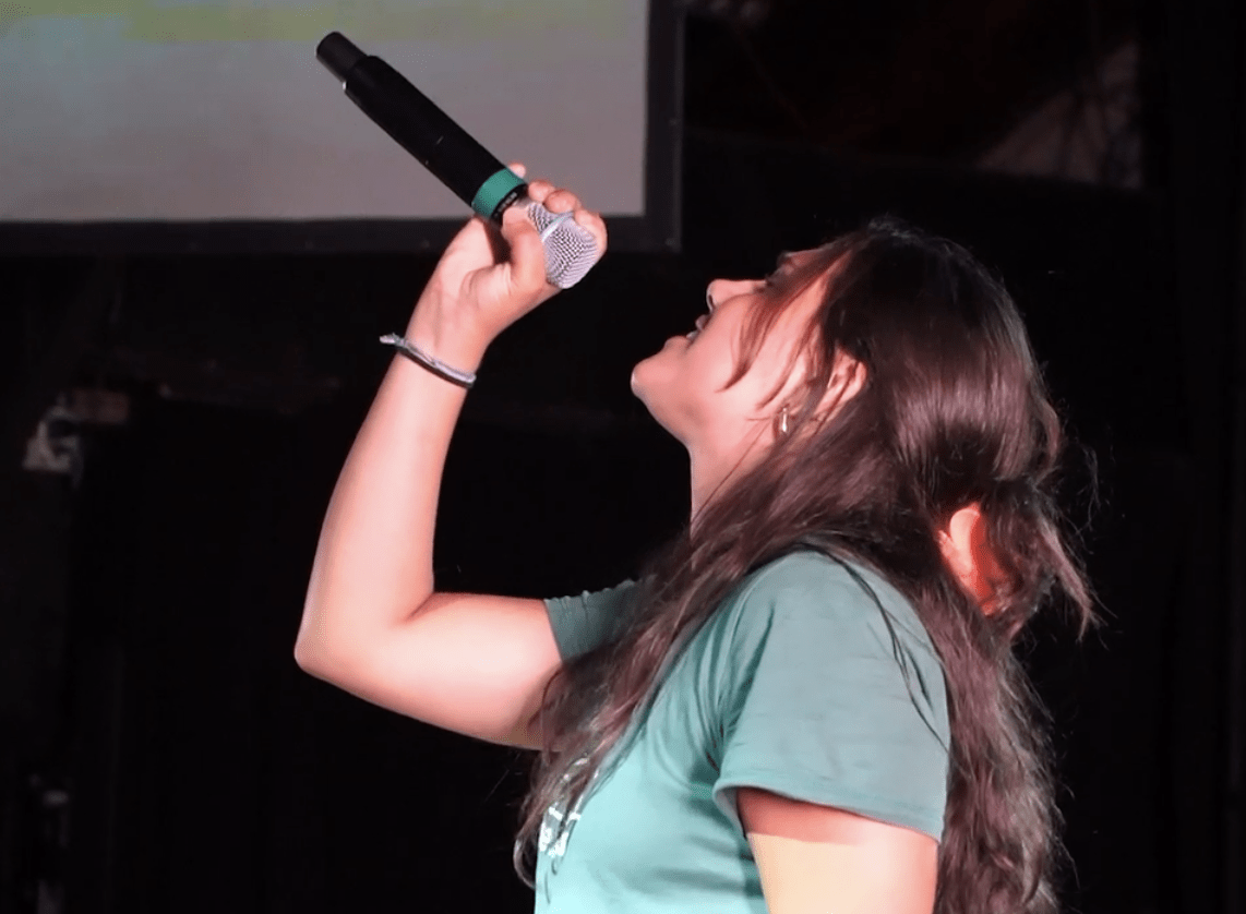 A photo of my friend singing in a worship band