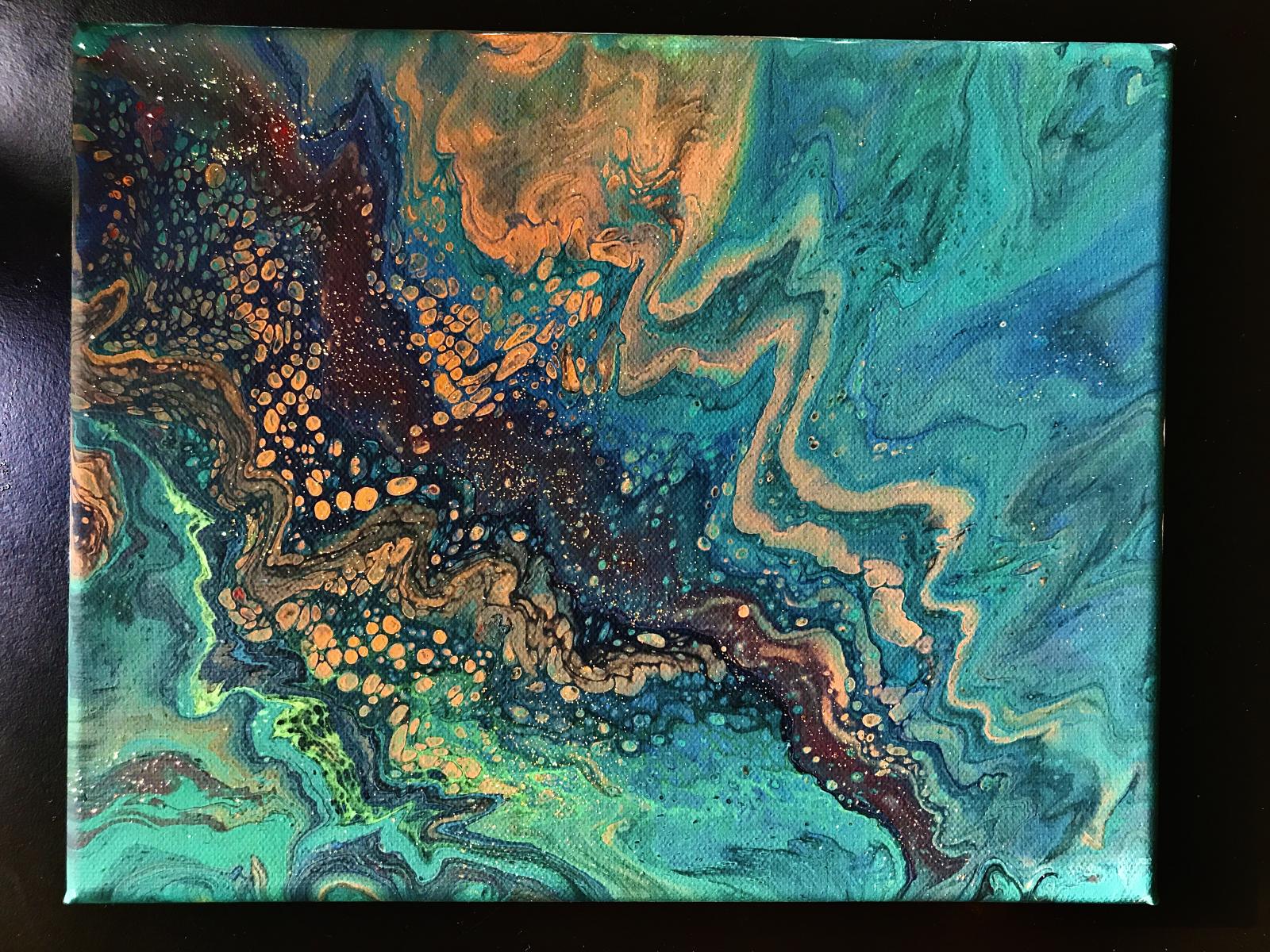 This is fluid art on canvas. The color palette stays in bright earth tones while creating a shape that resembles waves on a shore. The deep red color in center creates depth and definition to the orange cells as well as the overall piece.