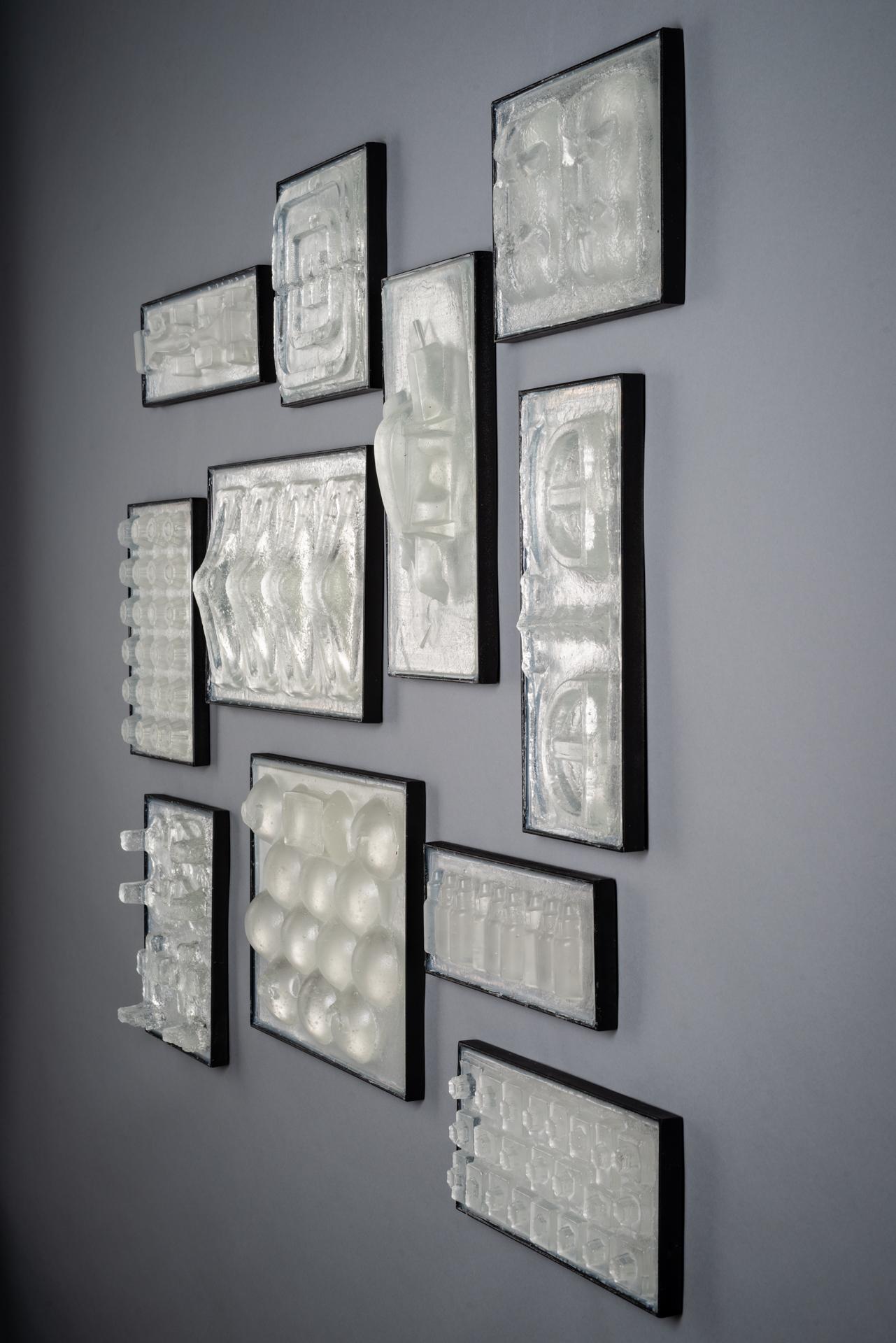 This piece references the vast amounts of material used for packing of goods, that ends up discarded instead of reused or recycled. It displays trash as art in salon style hanging.