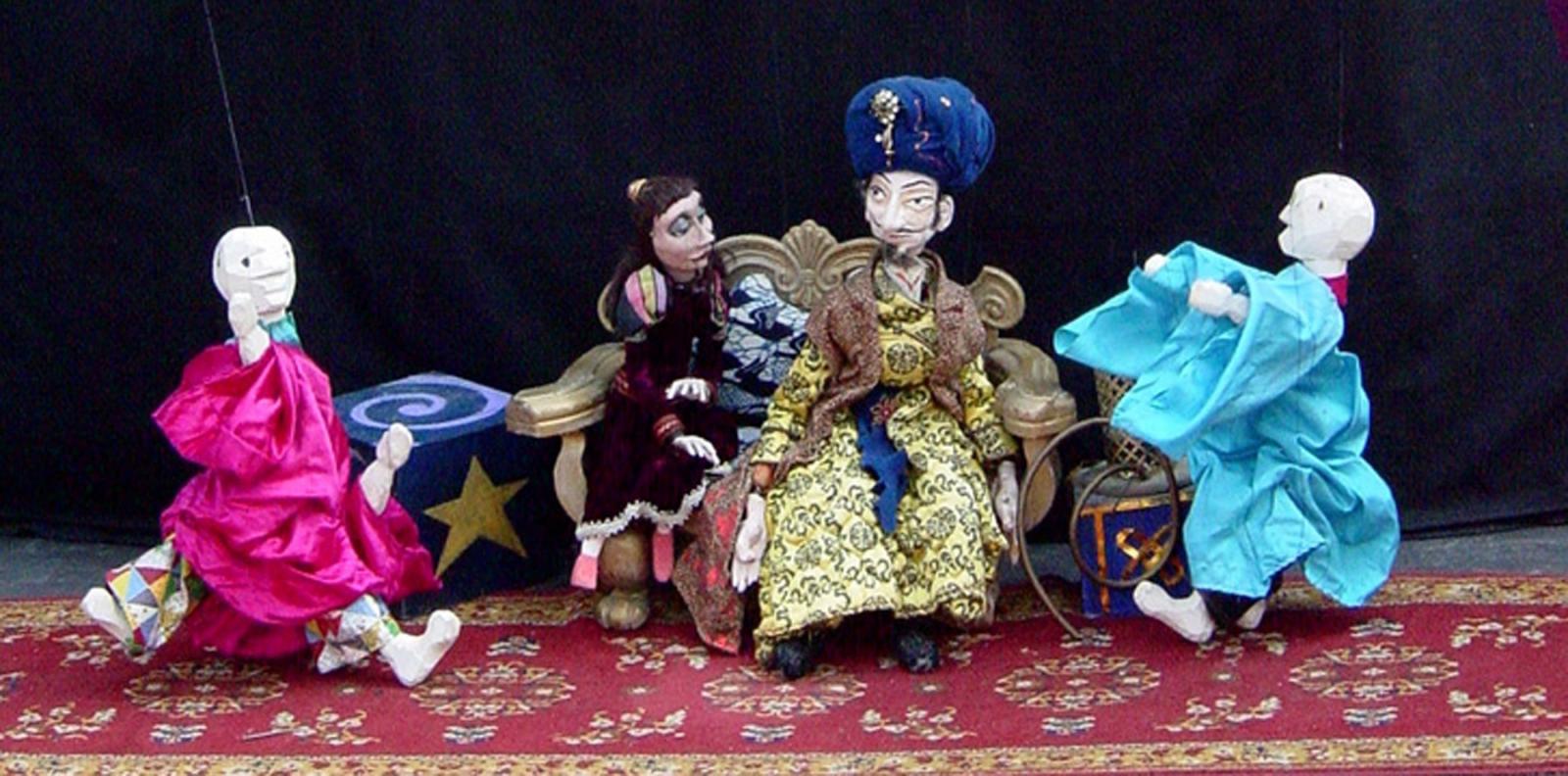 Trick marionettes perform for the sultan and his daughter.