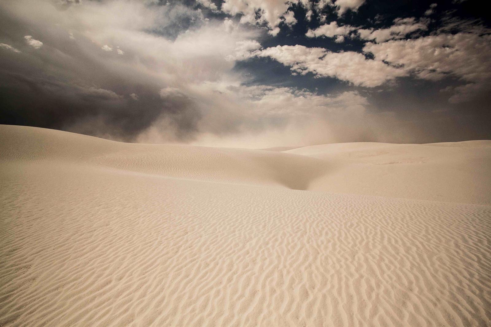 A sandstorm crests the dunes in White Sand National Monument, New Mexico.