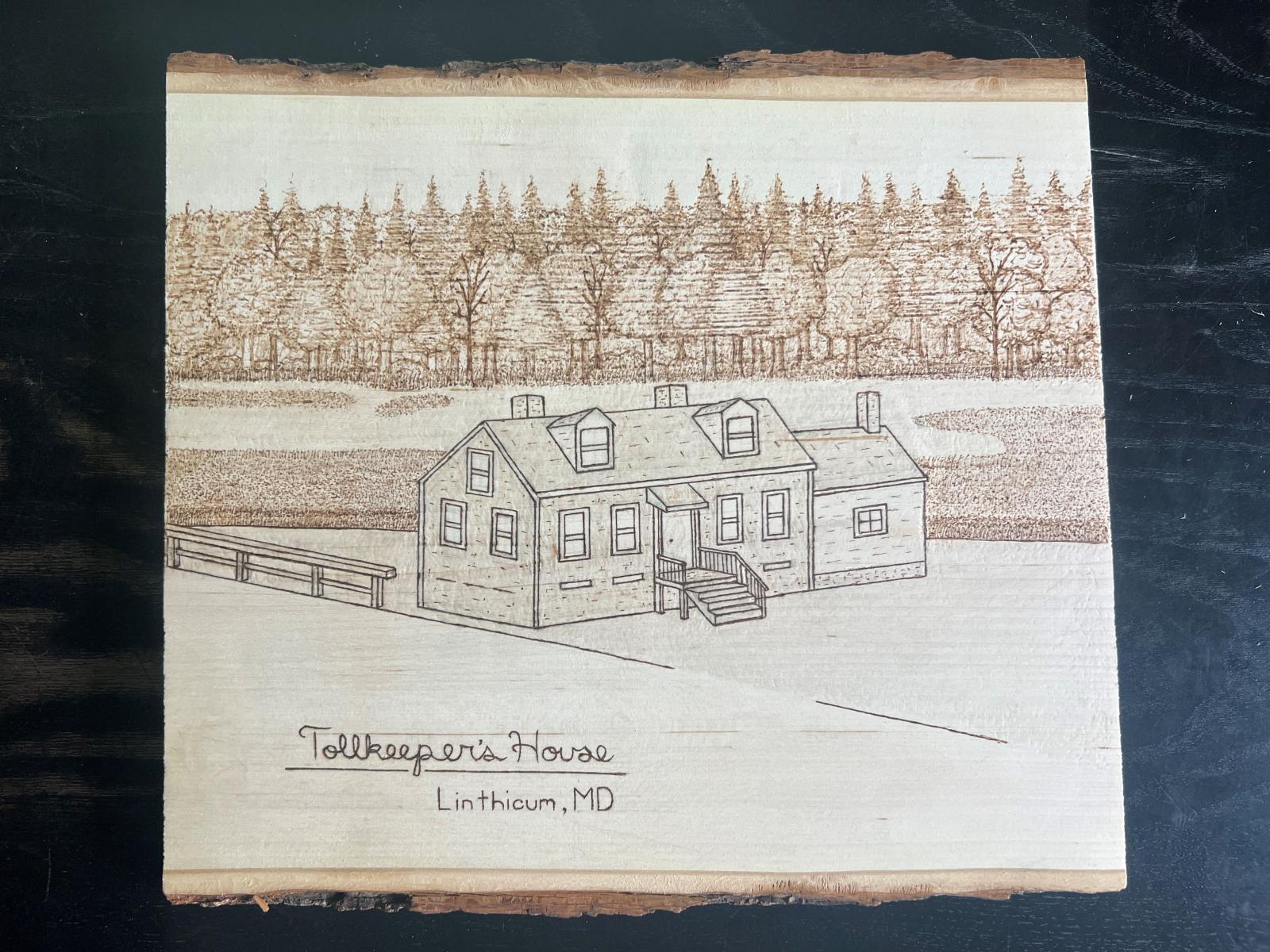 This piece of hand-burned basswood features an image of the historic Tollkeeper's House near the banks of the Patapsco River in Linthicum, Maryland.