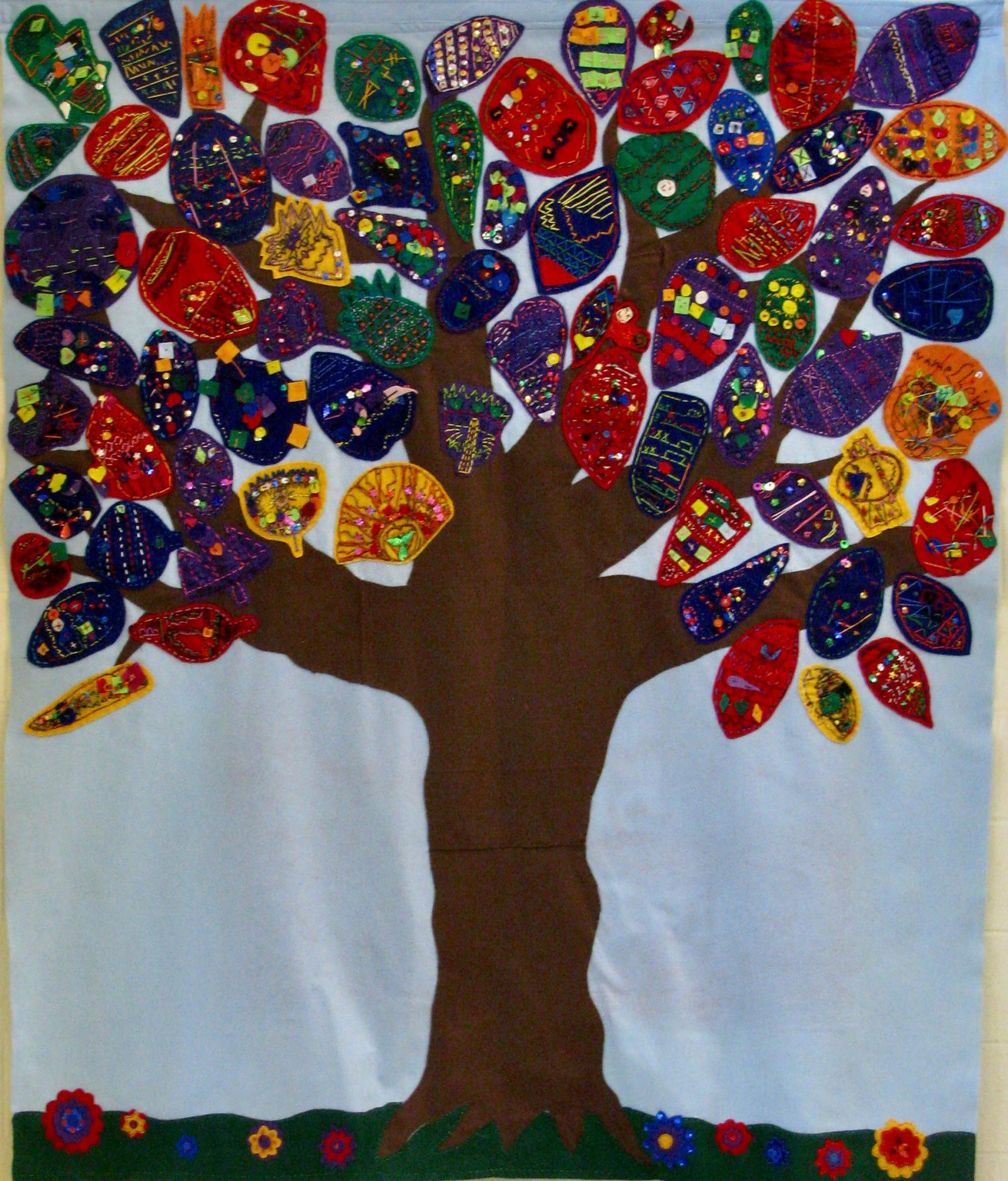 This 'family tree' represents the diverse school community at Vansville Elementary . Students in second grade learned about traditional embroidery styles from cultures represented in the school community. Each student created a leaf to represent themselves. The leaves were then attached to the mural by the artist. The mural is installed in the school media center.