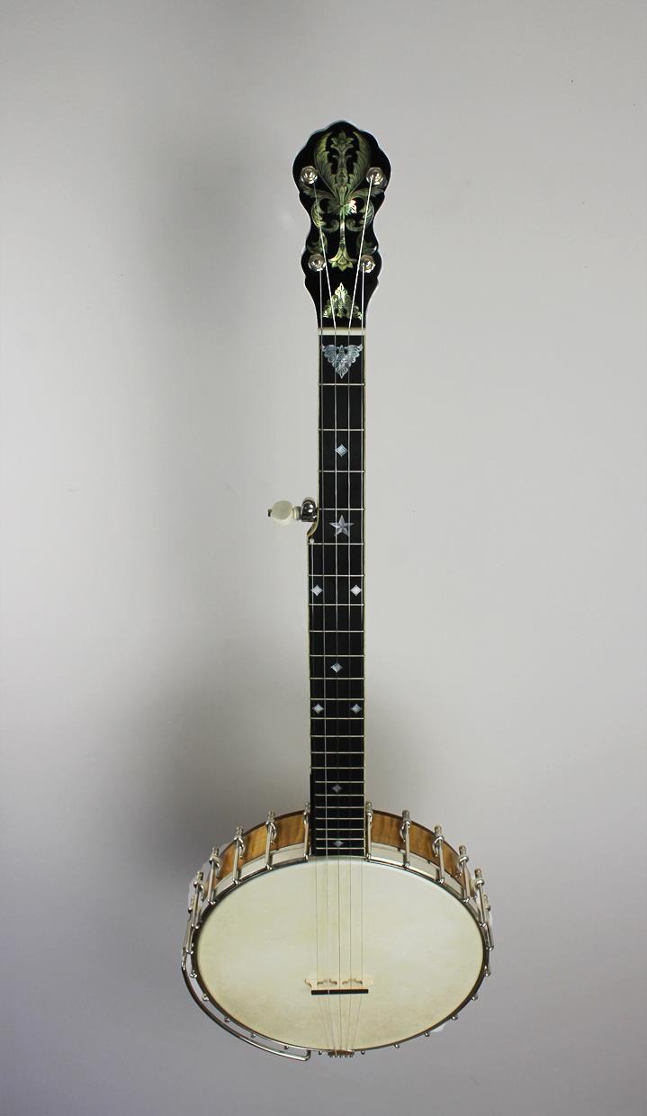Multiple pieces of maple, ebony and assorted thin veneers are glued up and, once dry, cut into the form of a neck. This neck is fit to the steam bent wooden rim.