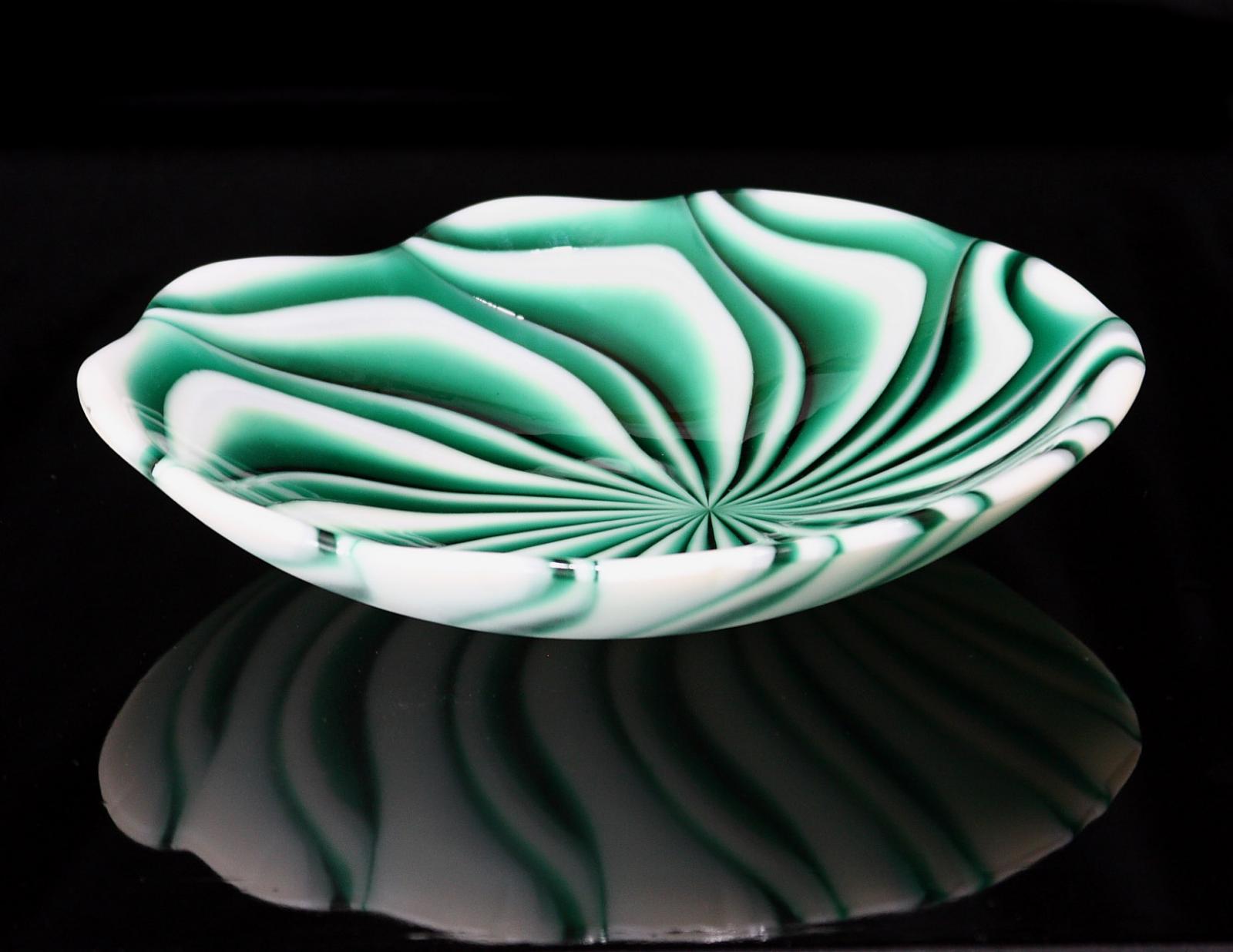 Fused glass spiral bowl made using the flow technique.  Opal and transparent glass.