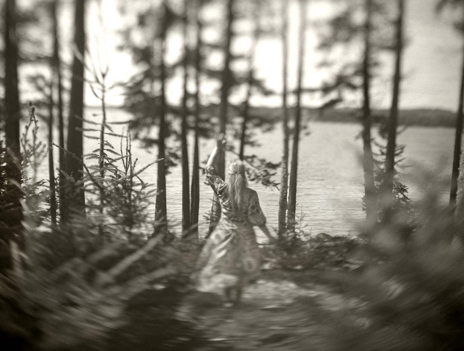 Cara Lee Wade’s photographs are stitched from the fabric of matriarchal memory through objects once held, places once known, and stories told. Through self-portraiture and the act of performance, she becomes both a witness and a vessel for the women who came before her, weaving familial artifacts, not as fixed truths, but as living, breathing echoes, where what is absorbed, altered, or lost is made visible again.
What began in mourning has become ritual. A story passed at the supper table, or a dusty teacup found in an antique store might spark a new image. Loss has ignited in Wade a commitment to absorb, preserve, and gather what remains, the stories, pieces, and  places holding them close before they, too, disappear.
Photographs are made with a 1947 4x5 Graflex and printed in small archival editions, each a tactile response to the fragility of remembrance.